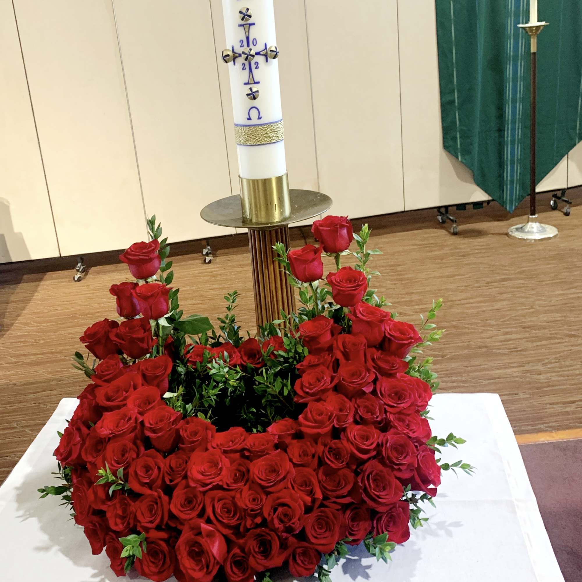 Pure red roses and greenery come together to create this beautiful urn