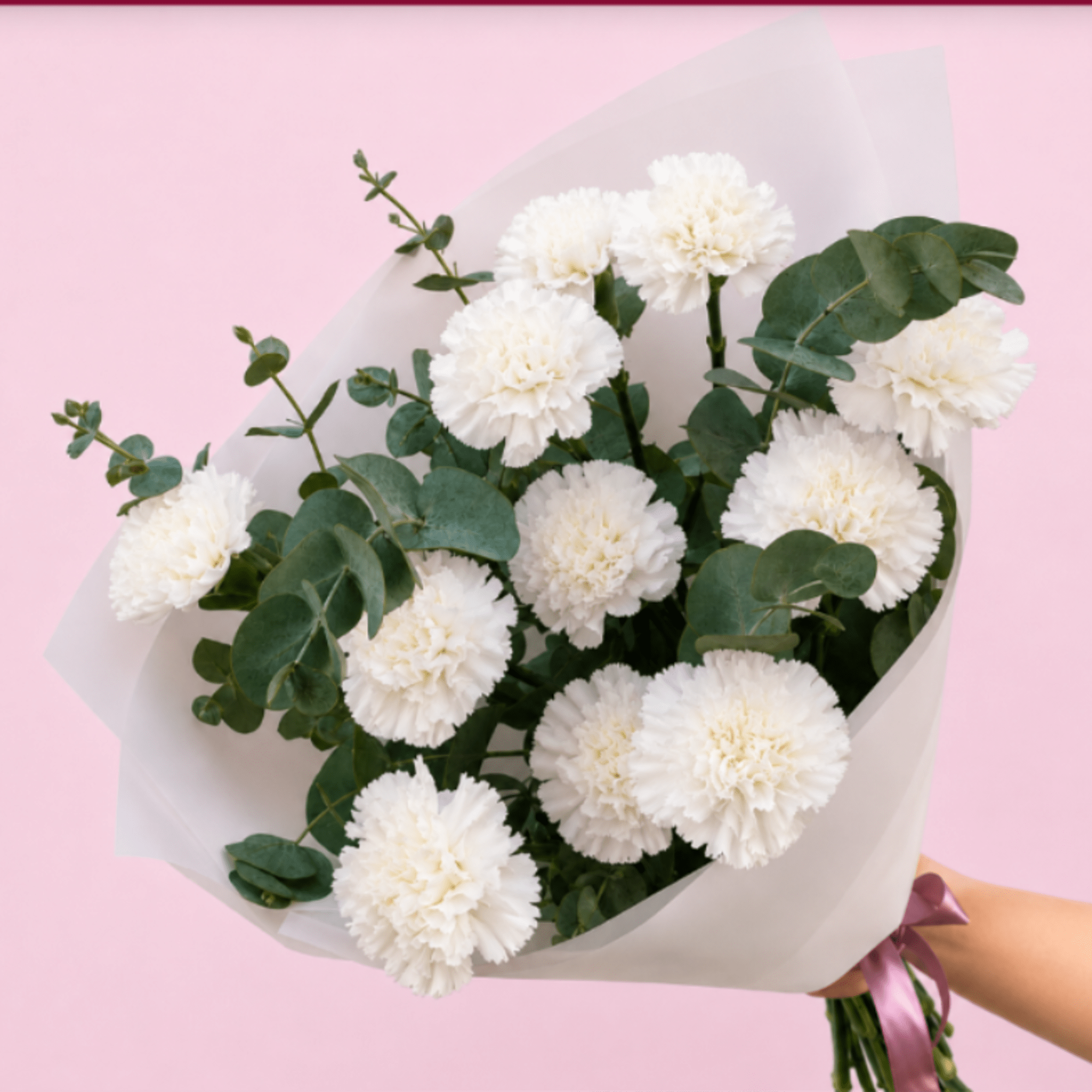 Pure white carnations gathered with soft eucalyptus create a calm, elegant bouquet