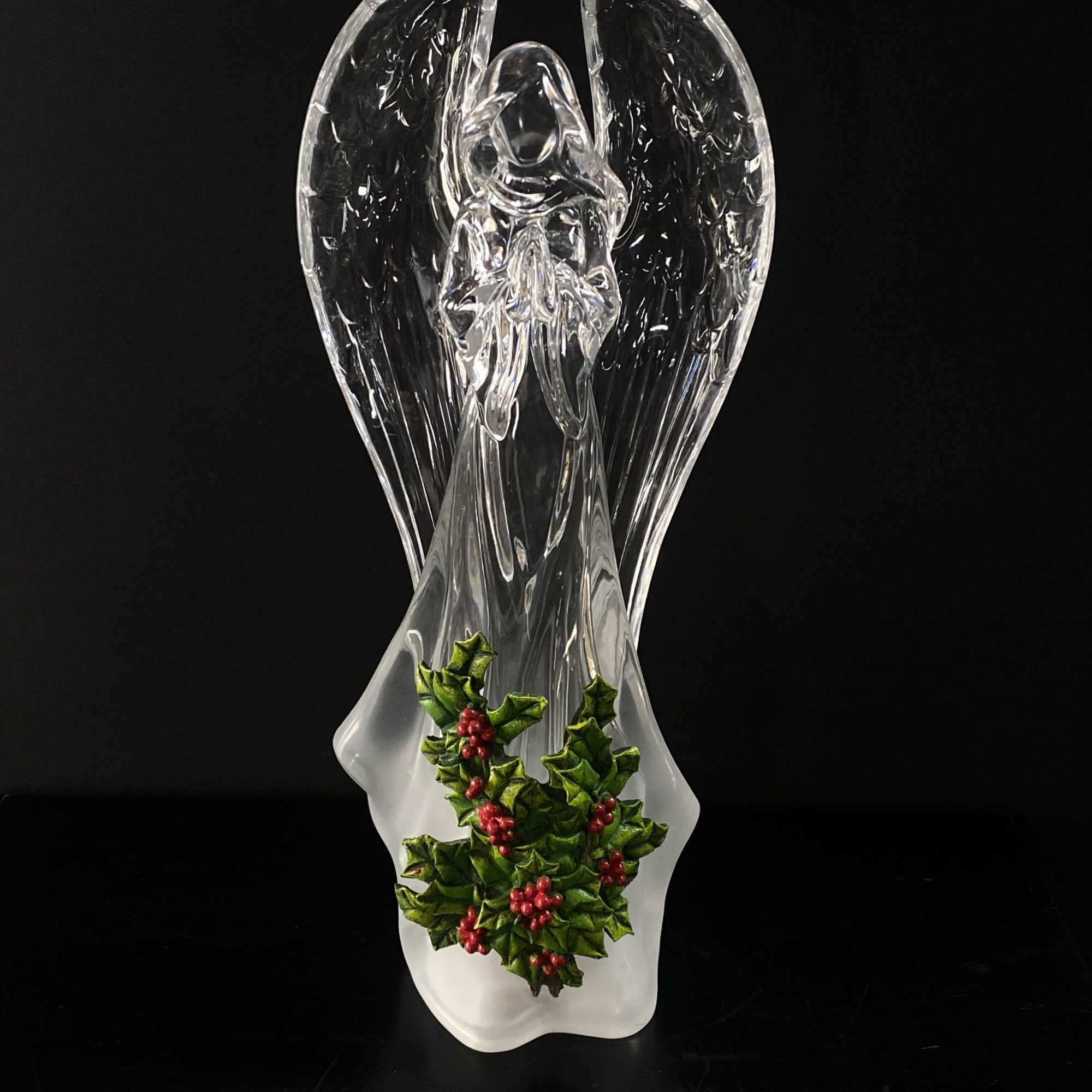 Clear glass angel figurine with holly decoration at the base