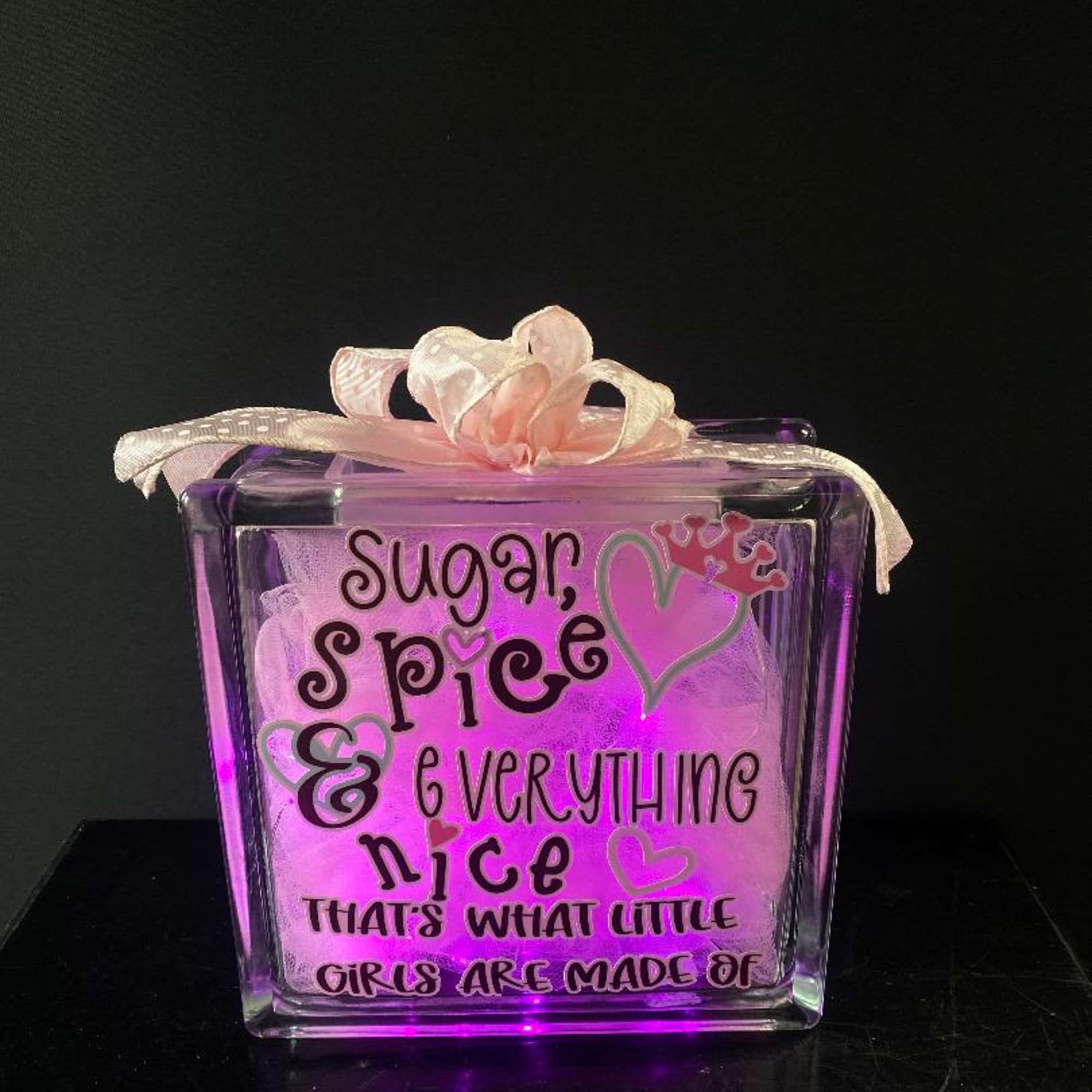 Purple glass block with pink ribbon and decorative text
