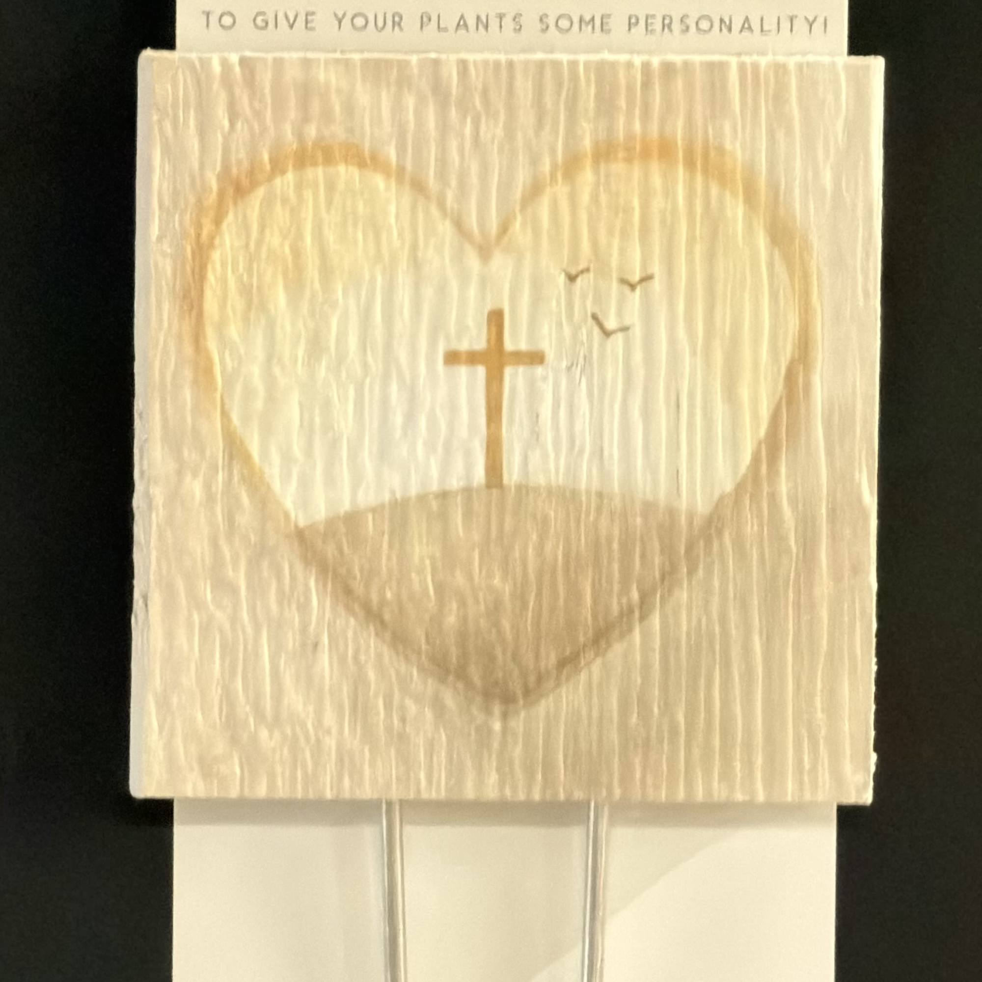 Packaged plant thought stake with a heart and cross design