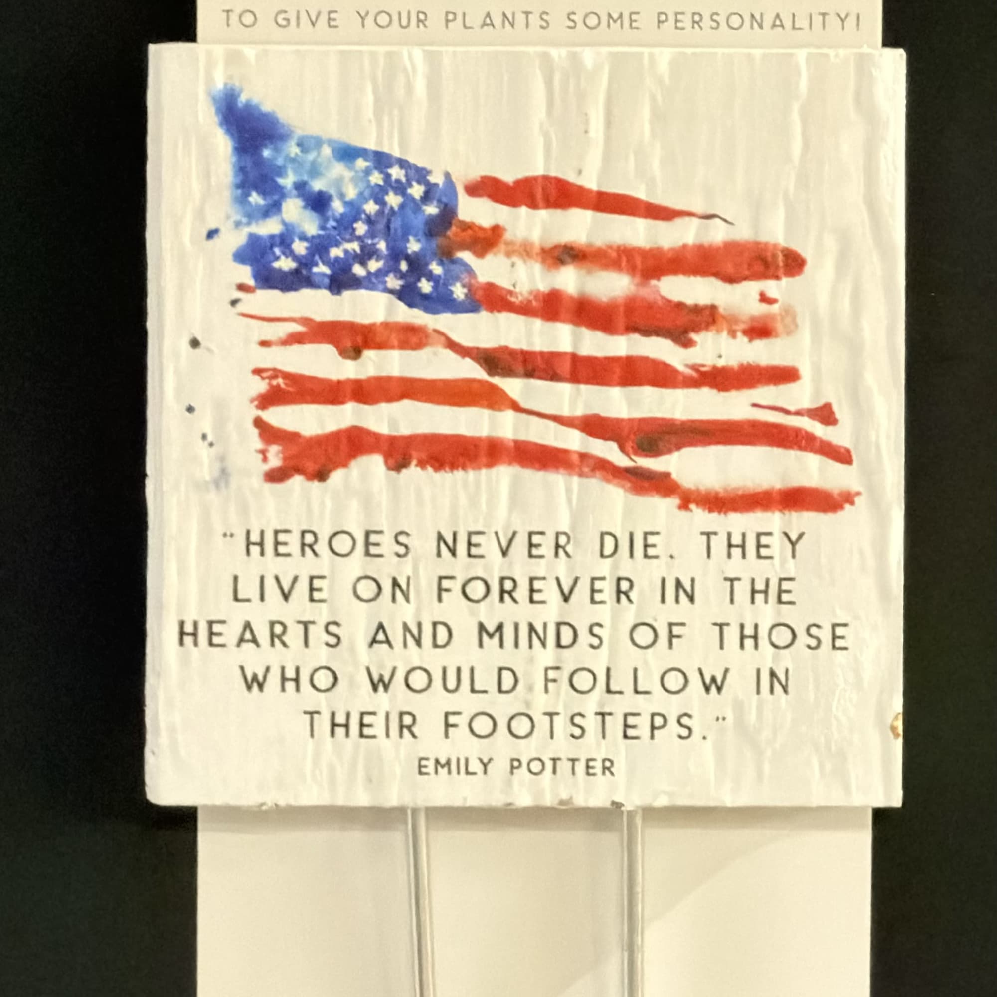 Packaged plant marker with an American flag design and memorial quote