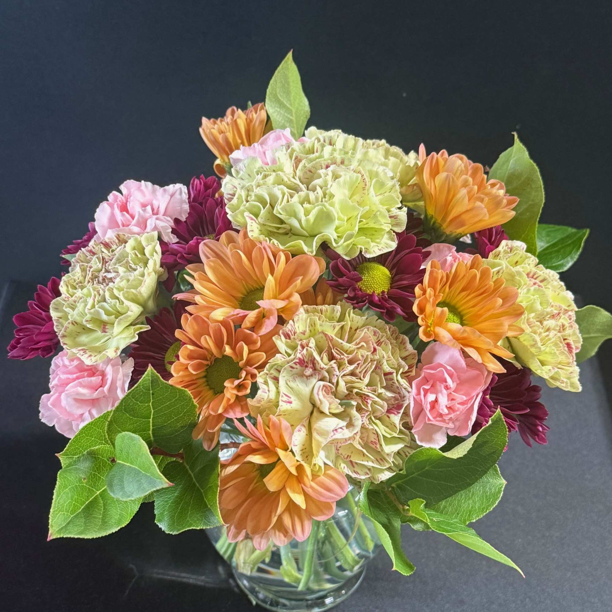 A small arrangement with carnations and daisies