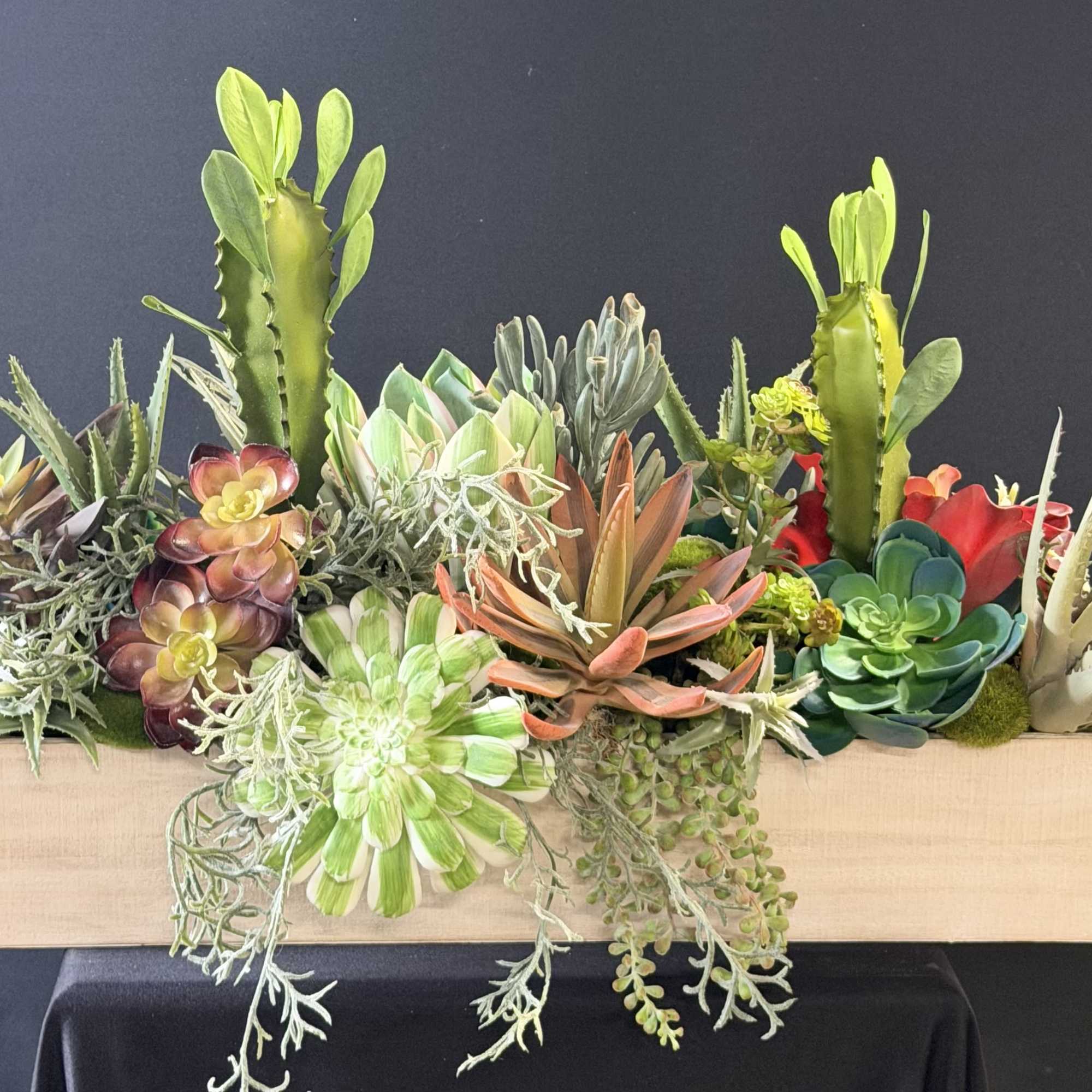 A sculptural mix of faux succulents and cactus-like plants arranged in a, photo 2 of 2