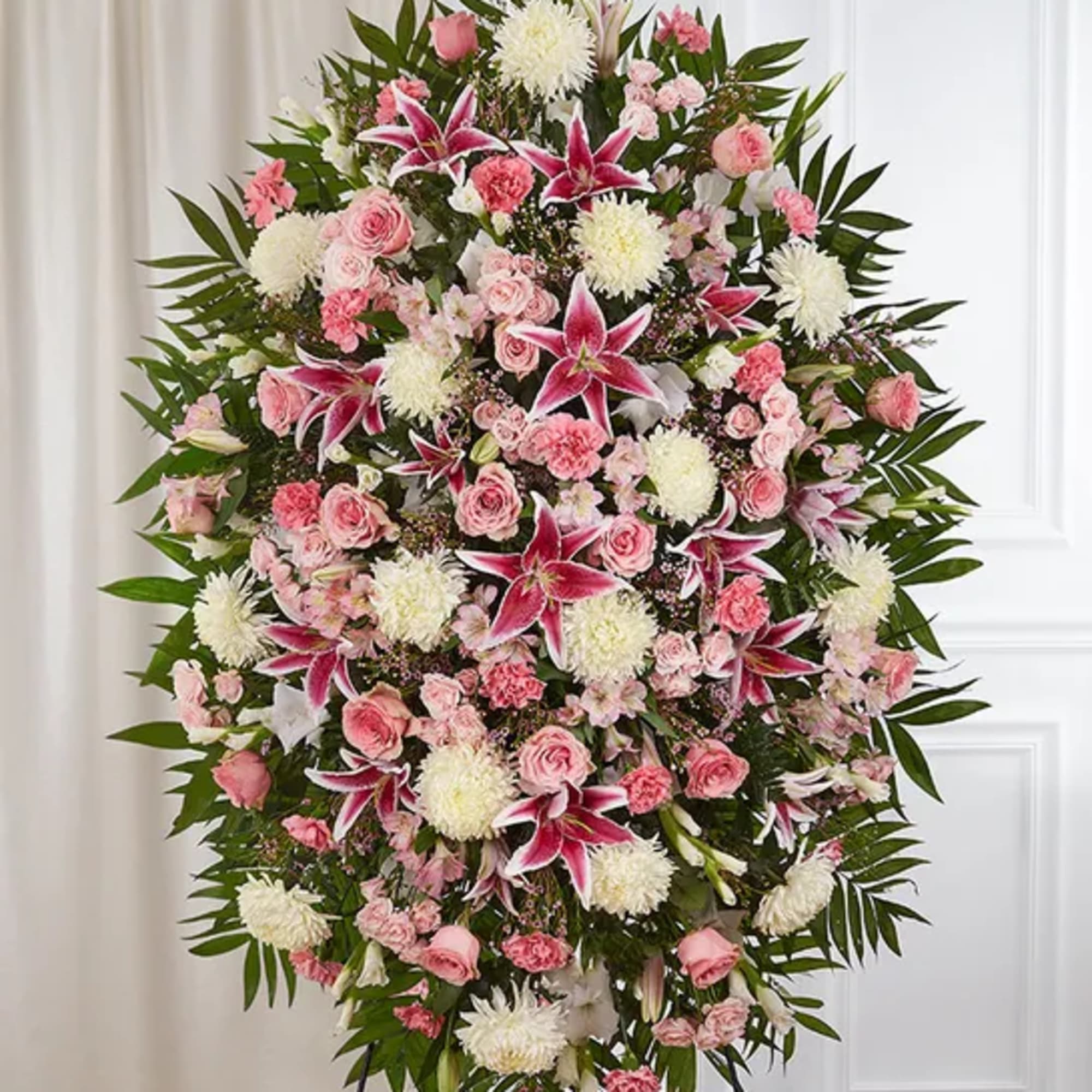 Large standing spray of pink and white flowers with lilies and roses