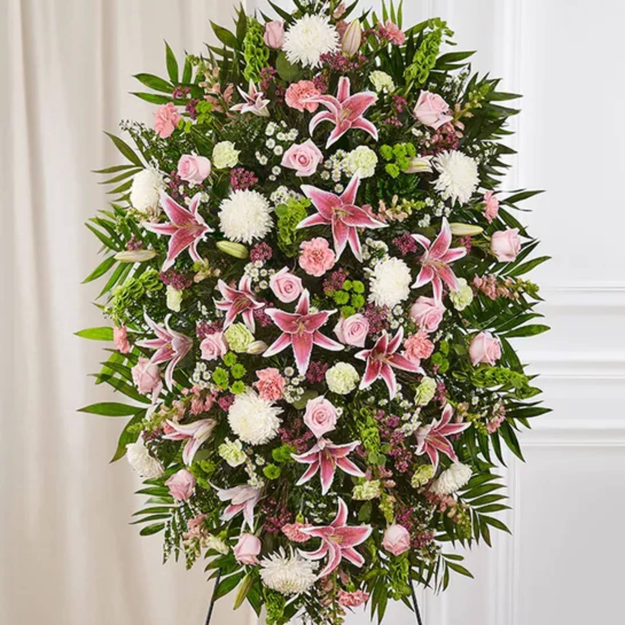 Large standing spray of pink and white flowers on an easel