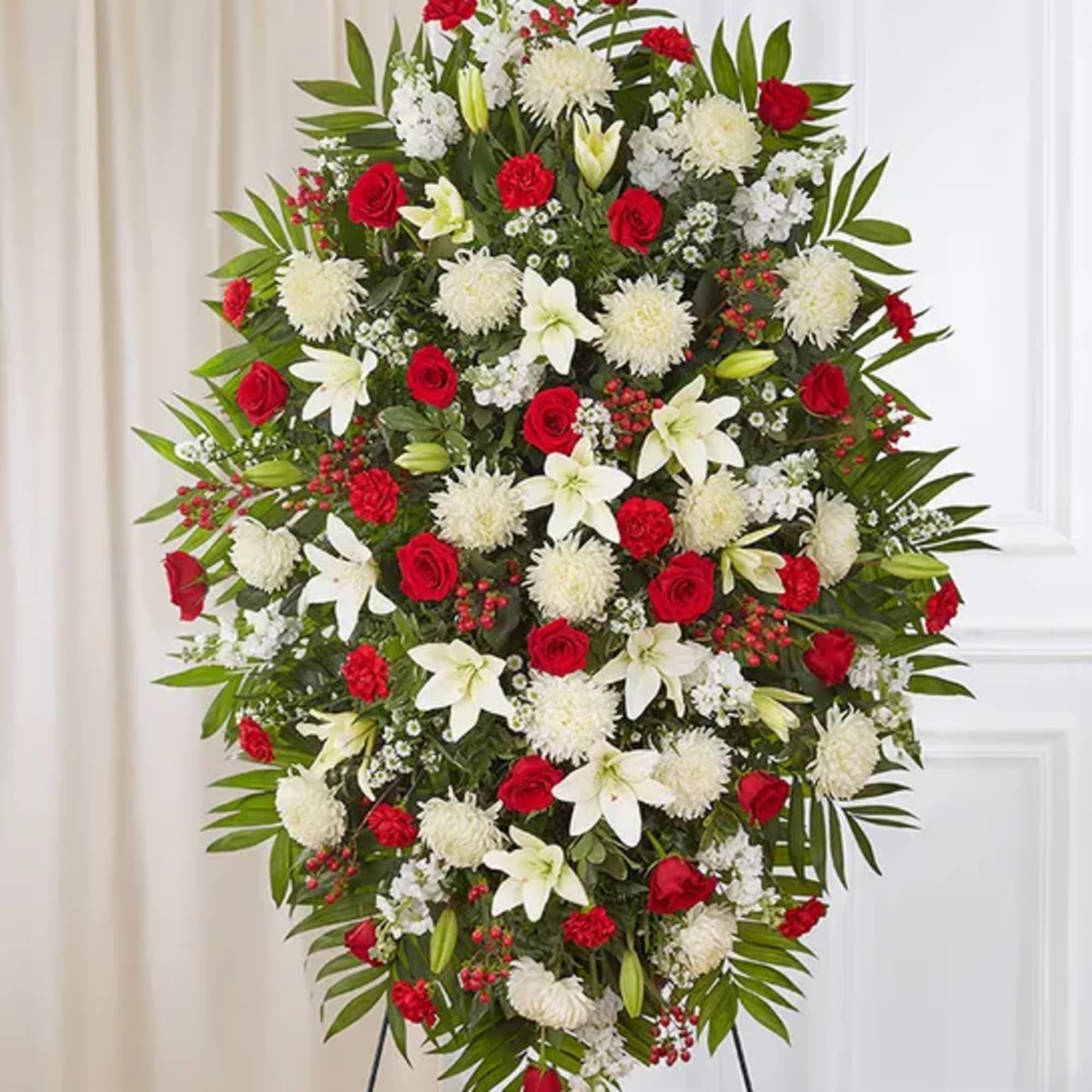 Standing floral spray with red roses, white lilies, and white mums