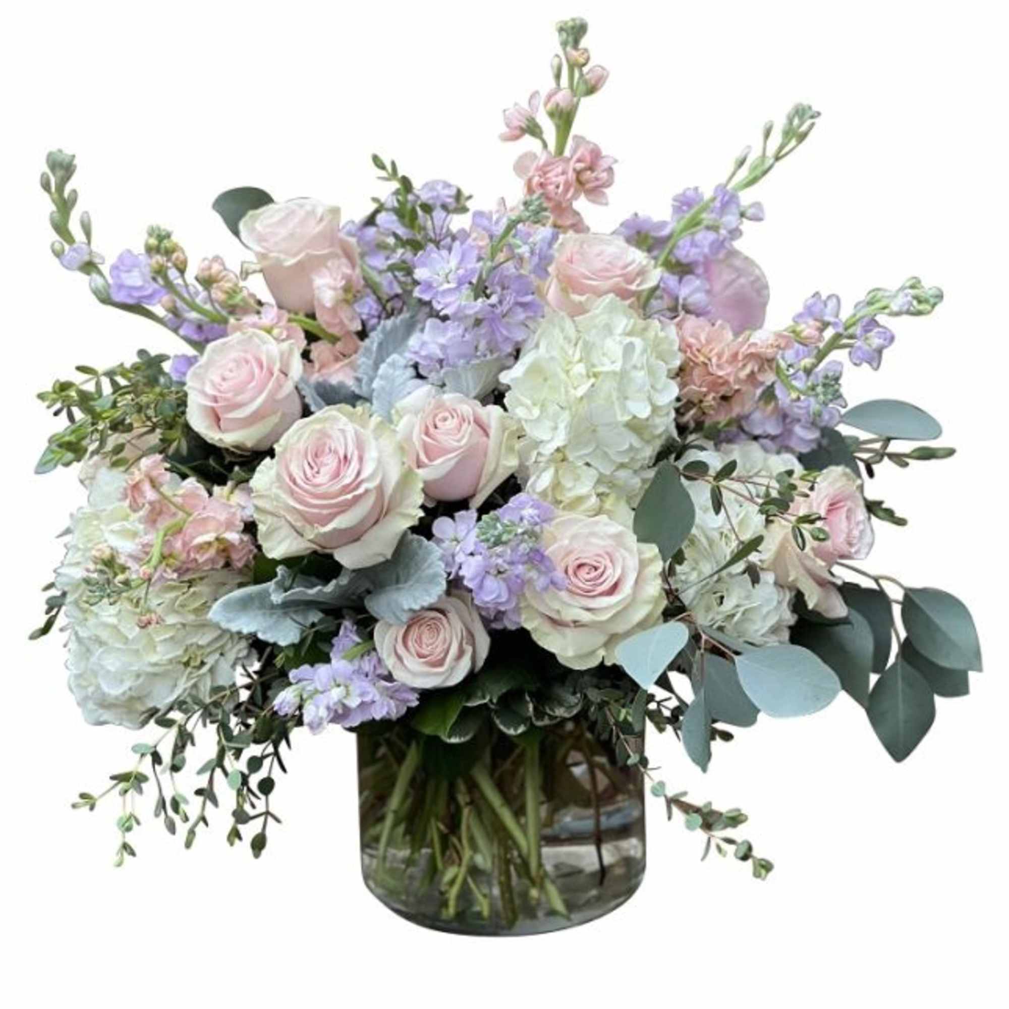 Pastel bouquet of roses and lavender flowers in a glass vase