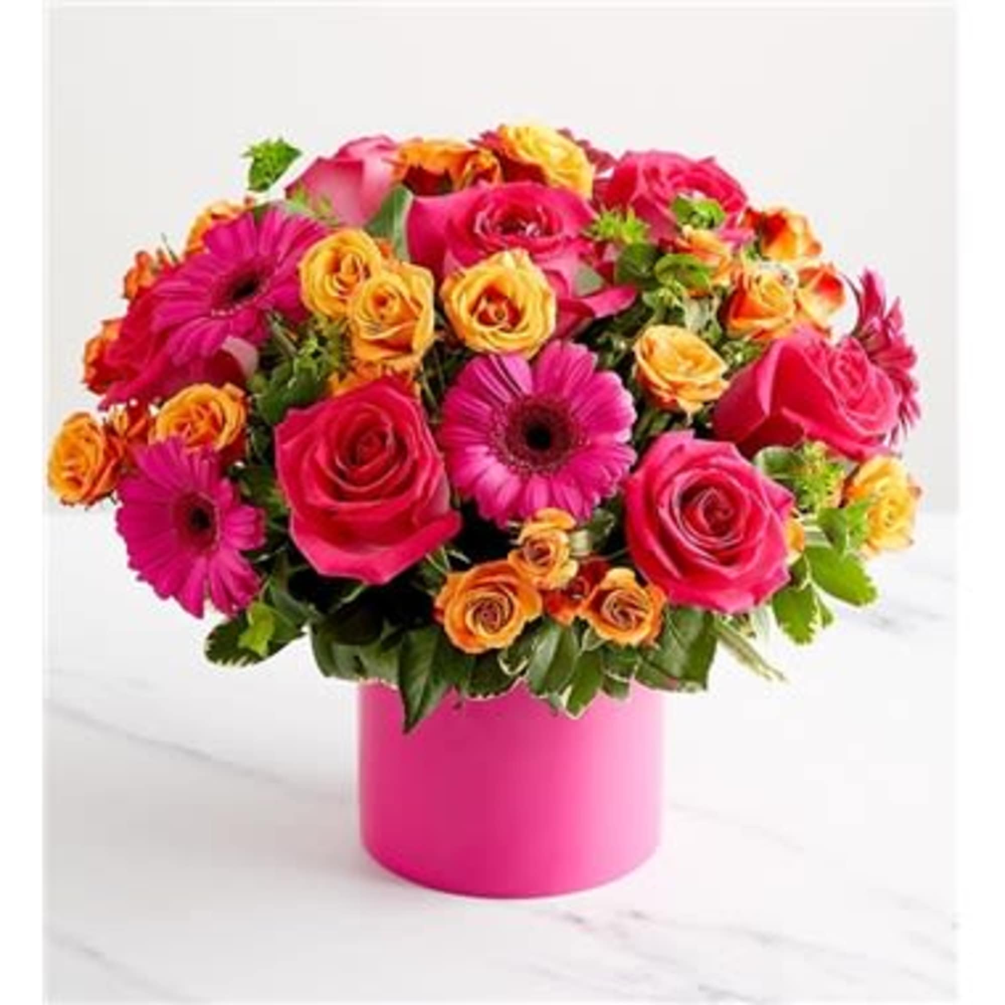 Bouquet of pink roses and gerbera daisies in a pink vase