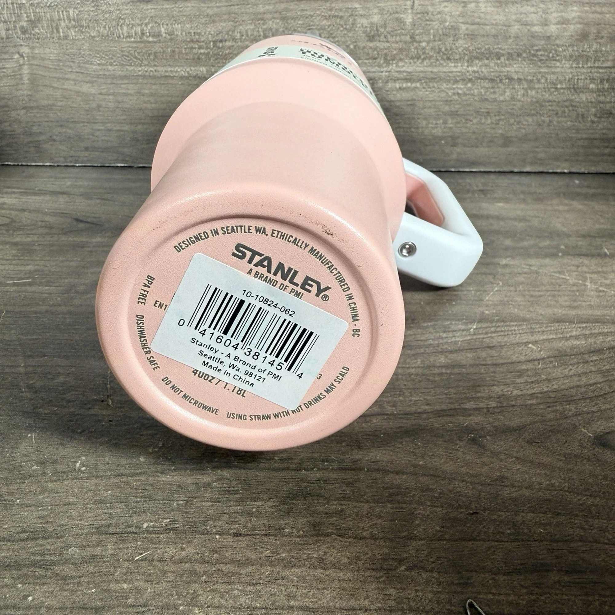 Pink Stanley mug with a white handle and barcode label