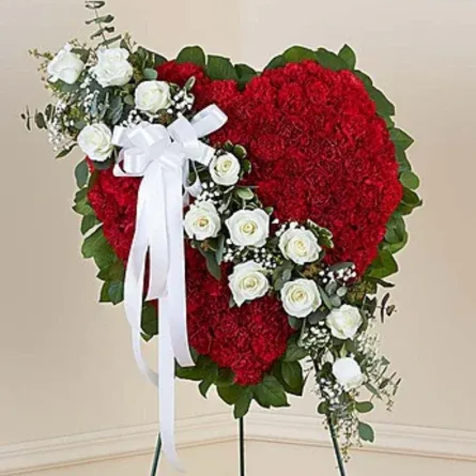 This solid red heart standing spray, accented with a slash of beautiful