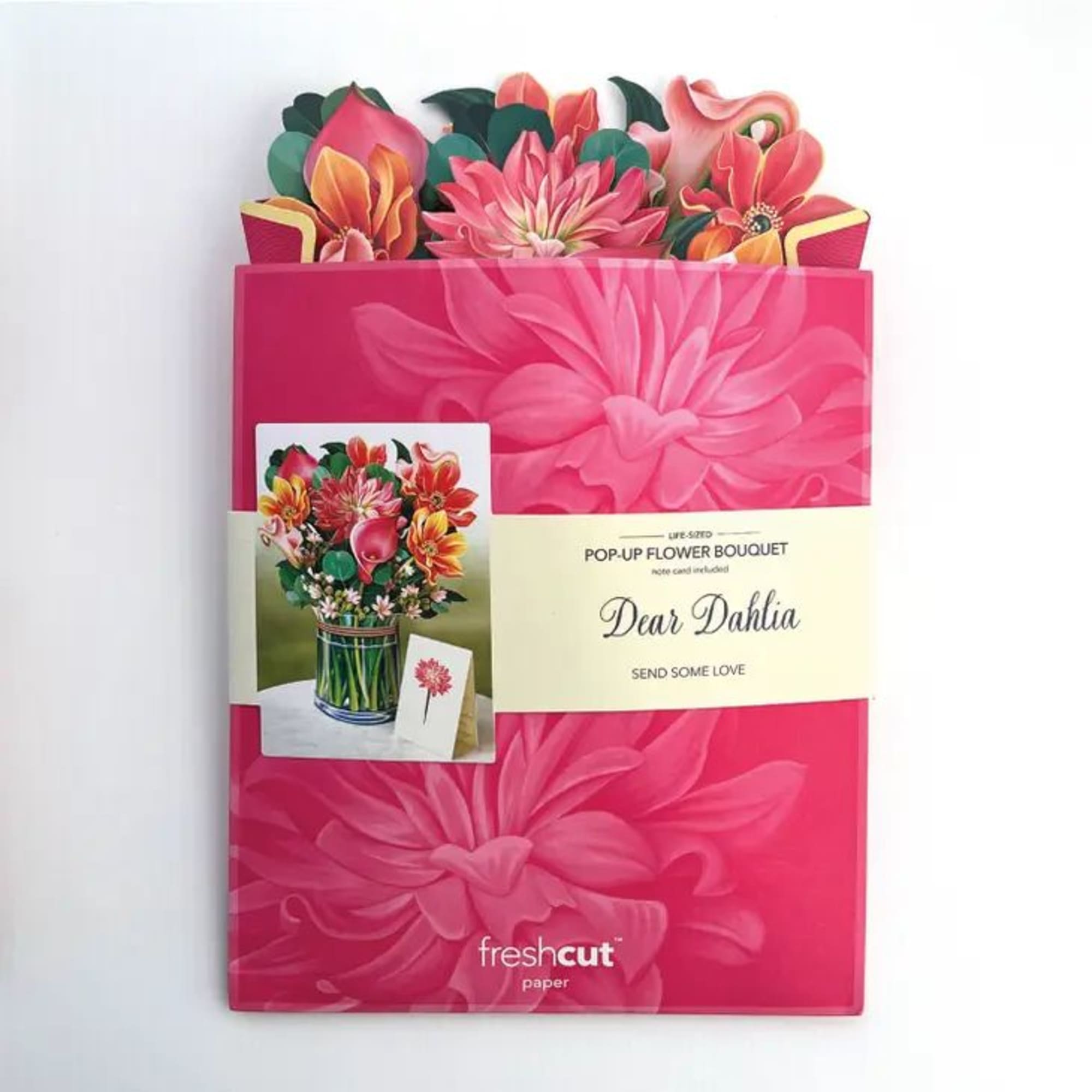 Flat pink package with a pop-up paper dahlia bouquet card peeking from the top