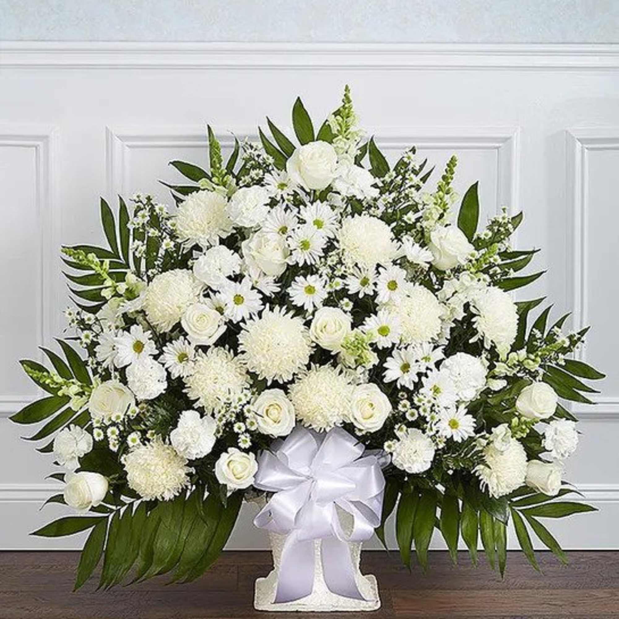 Large white arrangement with roses, mums, and daisies in a white container with bow