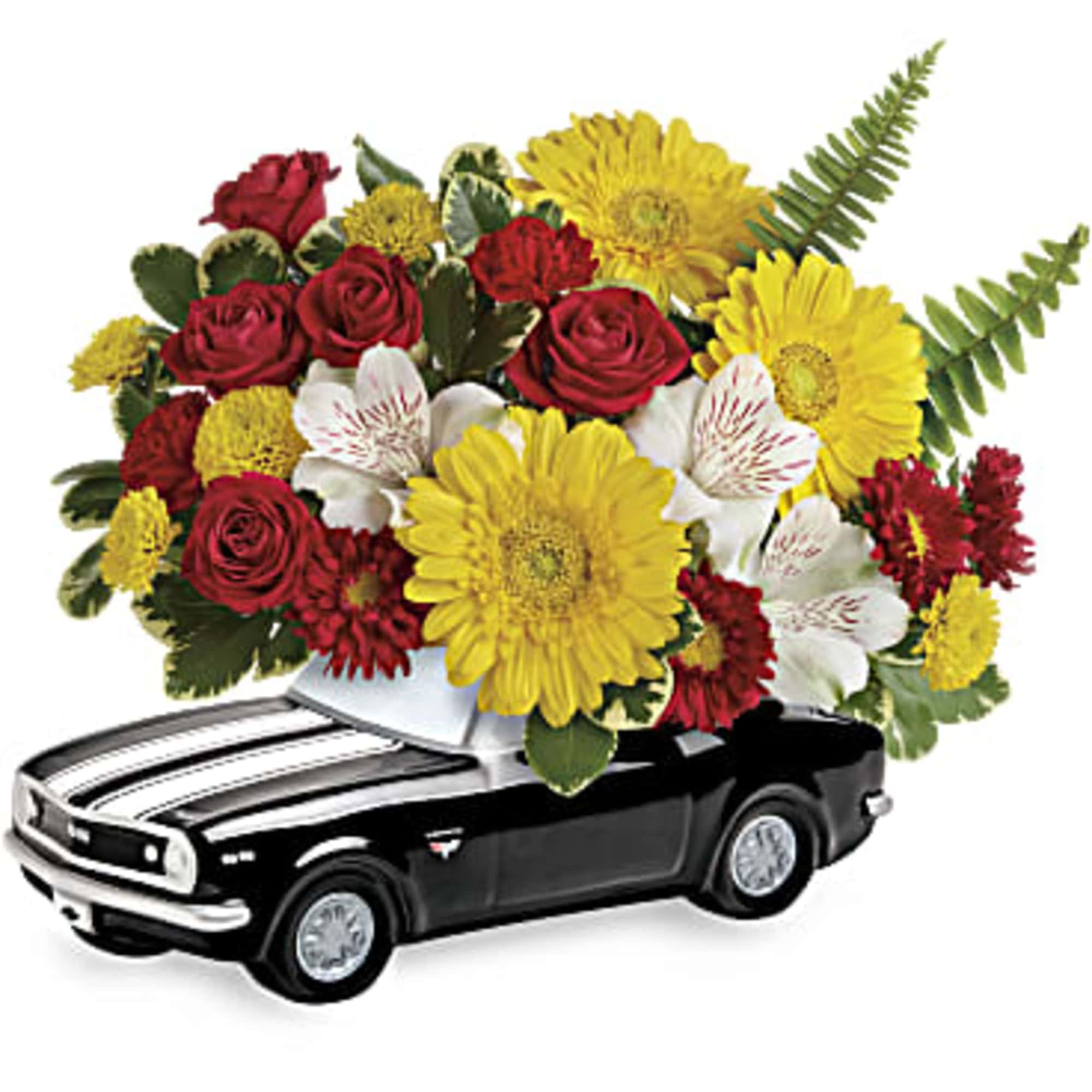 Mixed red, yellow, and white flower arrangement displayed in a black car-shaped keepsake container