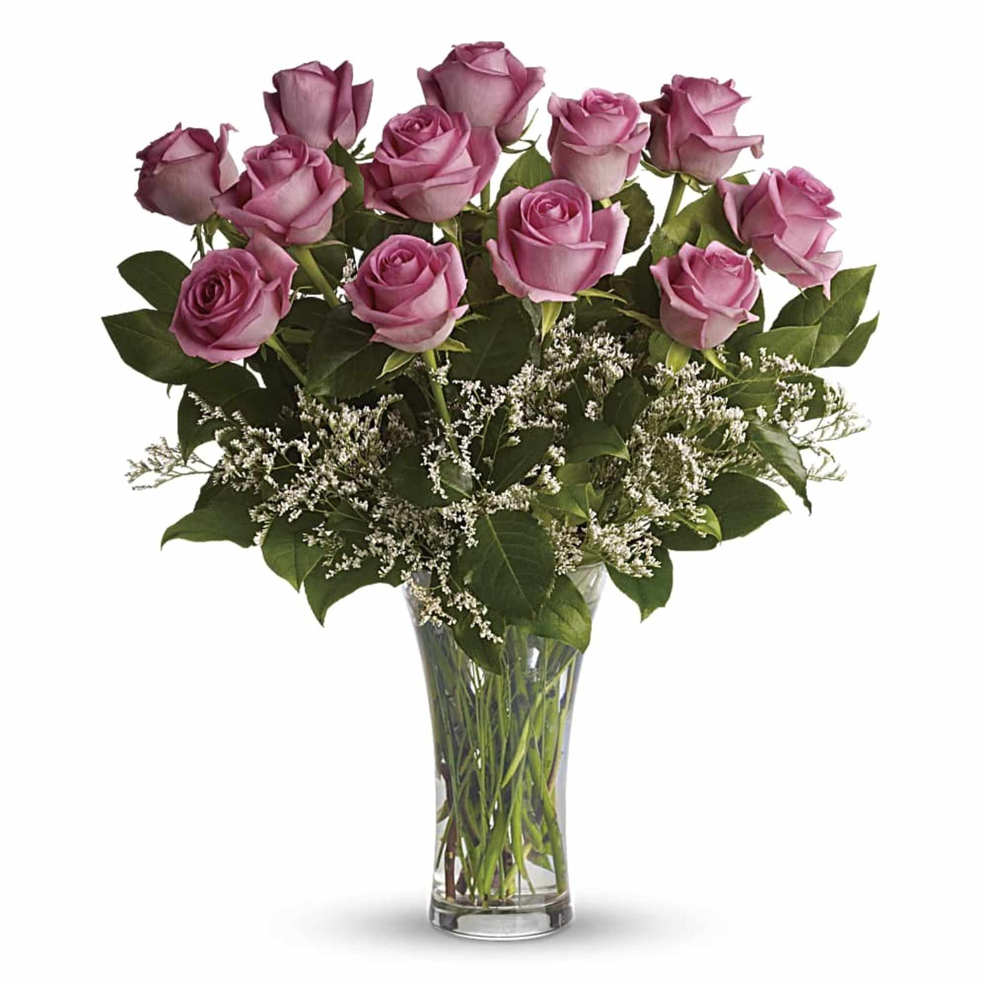 Dozen pink roses with white filler flowers in a clear glass vase