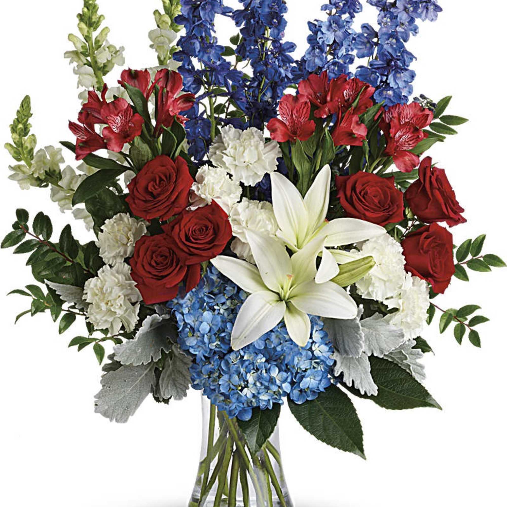 Tall red, white, and blue flower arrangement in a clear glass vase.