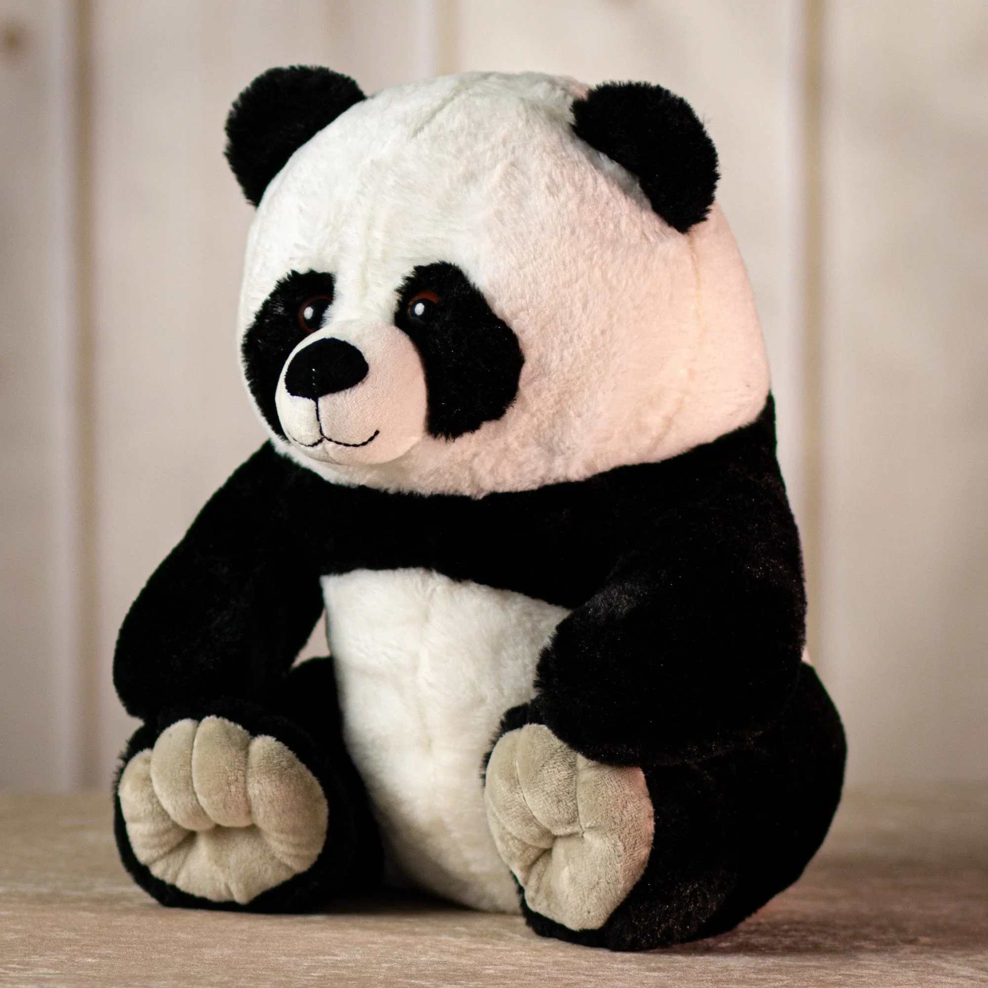 Black and white plush panda bear sitting upright