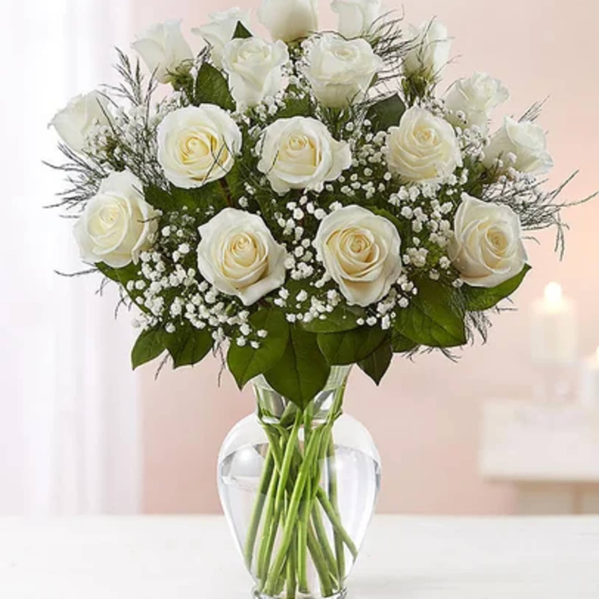 White roses arranged in a clear glass vase