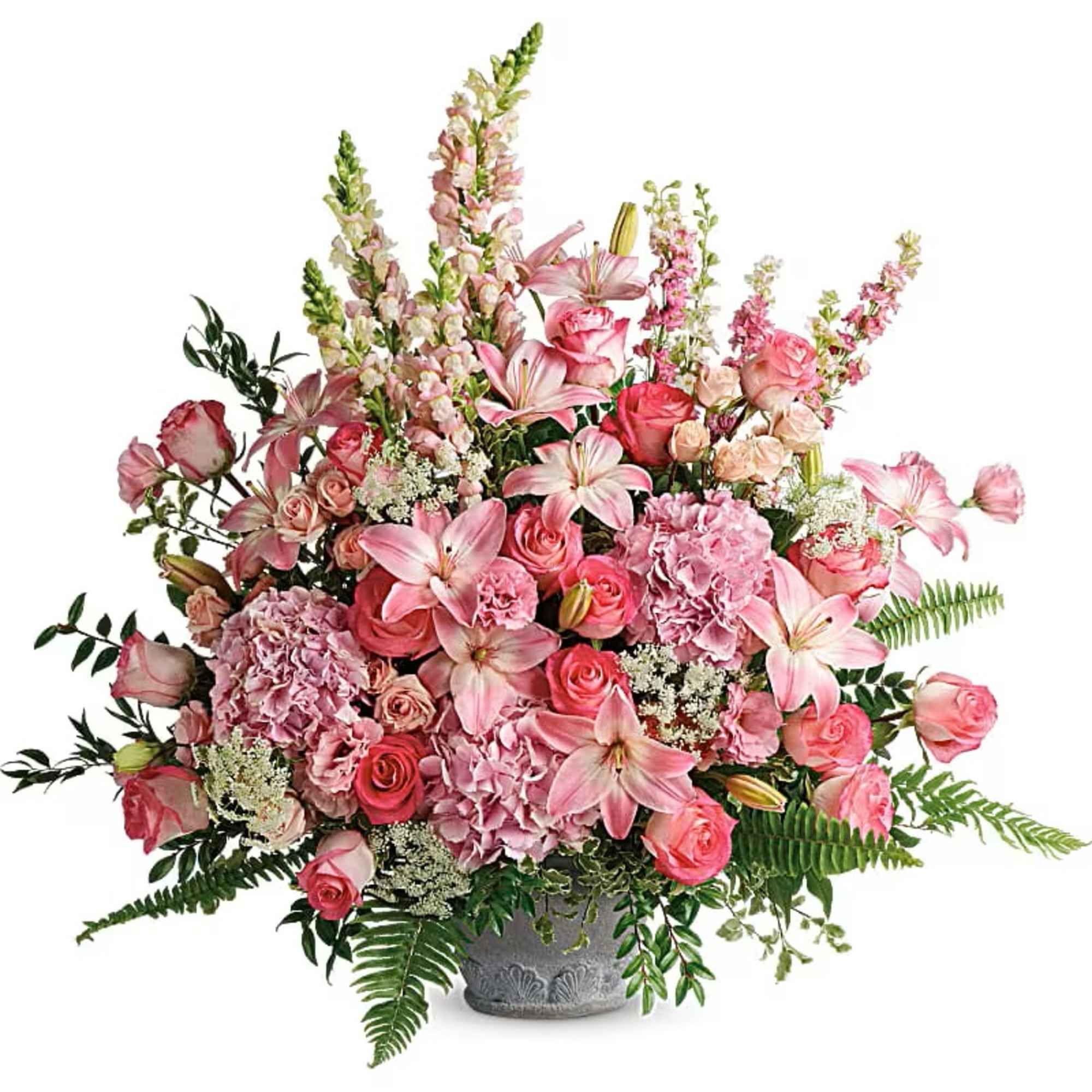 Pink floral arrangement in a gray vase with roses and lilies