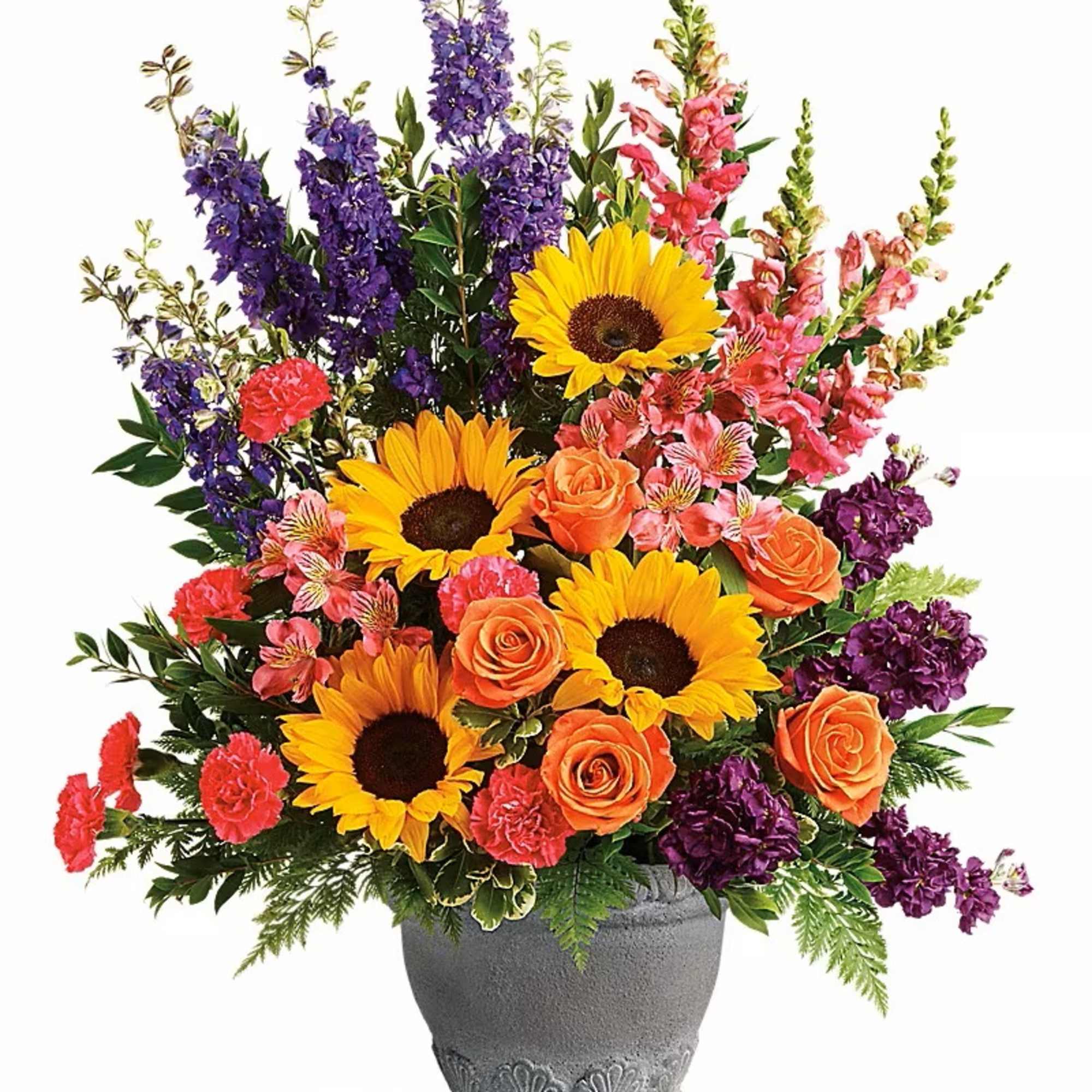 Colorful bouquet with sunflowers, roses, and purple blooms in a gray vase
