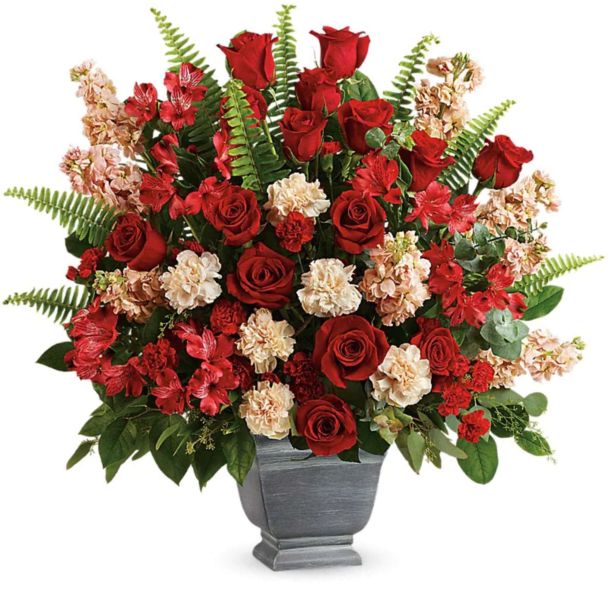 Red roses and carnations in a gray urn vase
