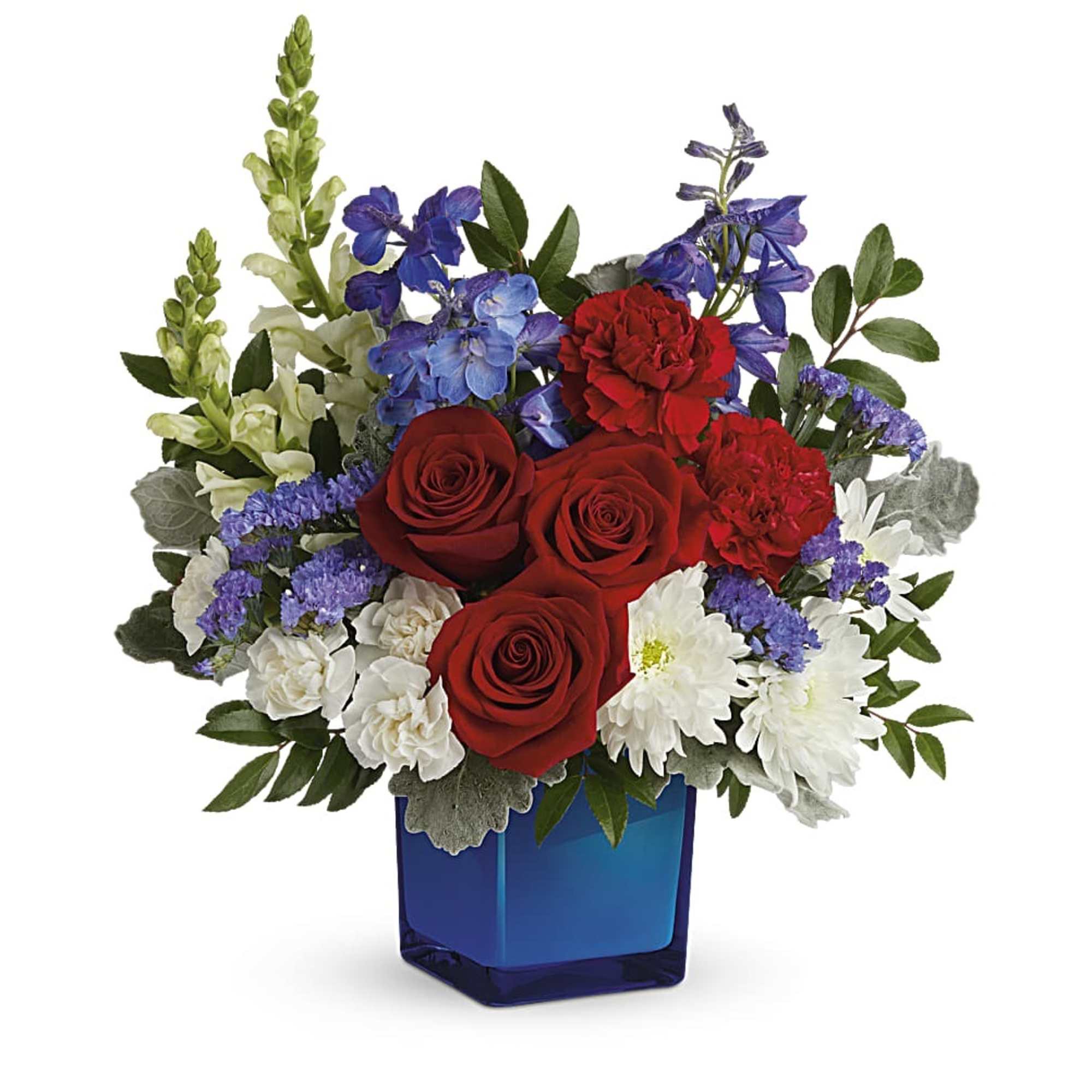 Red roses, white daisies, and purple flowers in a blue square vase