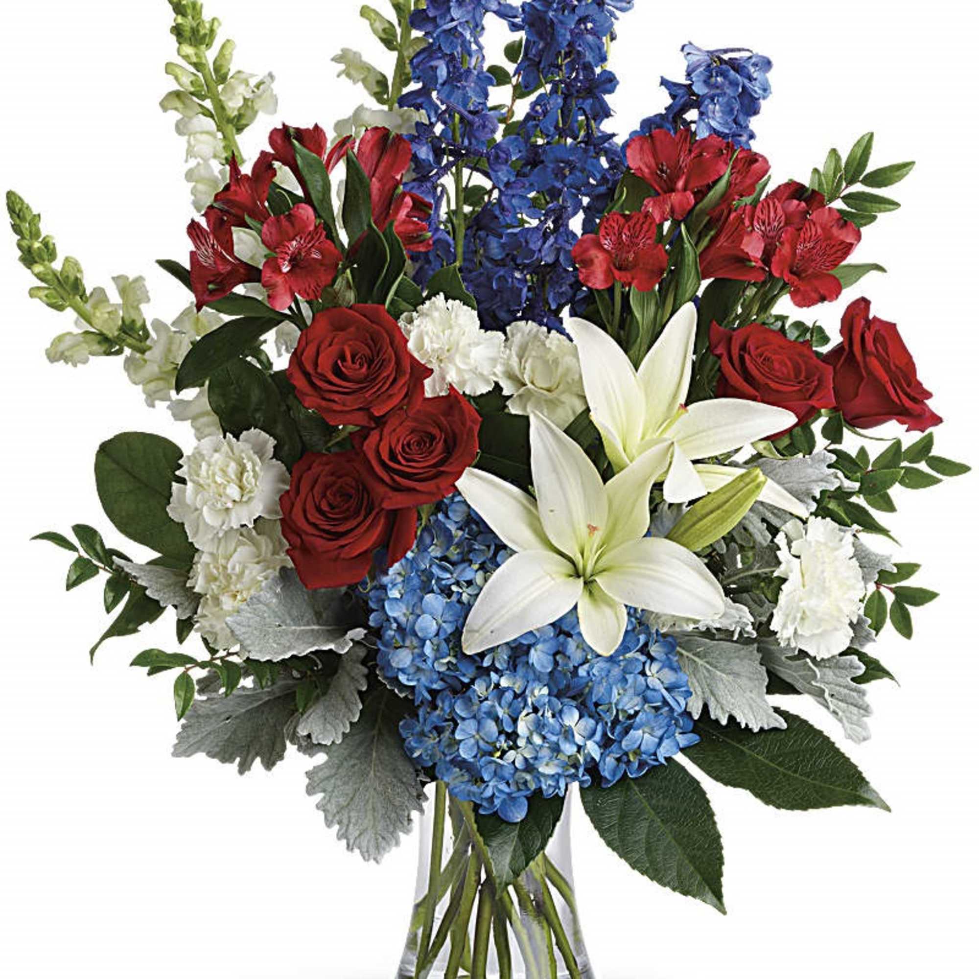 Bouquet of red roses, blue flowers, and white lilies in a glass vase