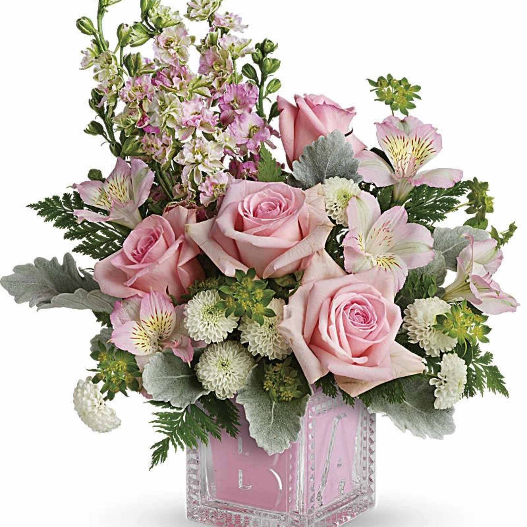 Pink roses and alstroemeria in a clear square vase