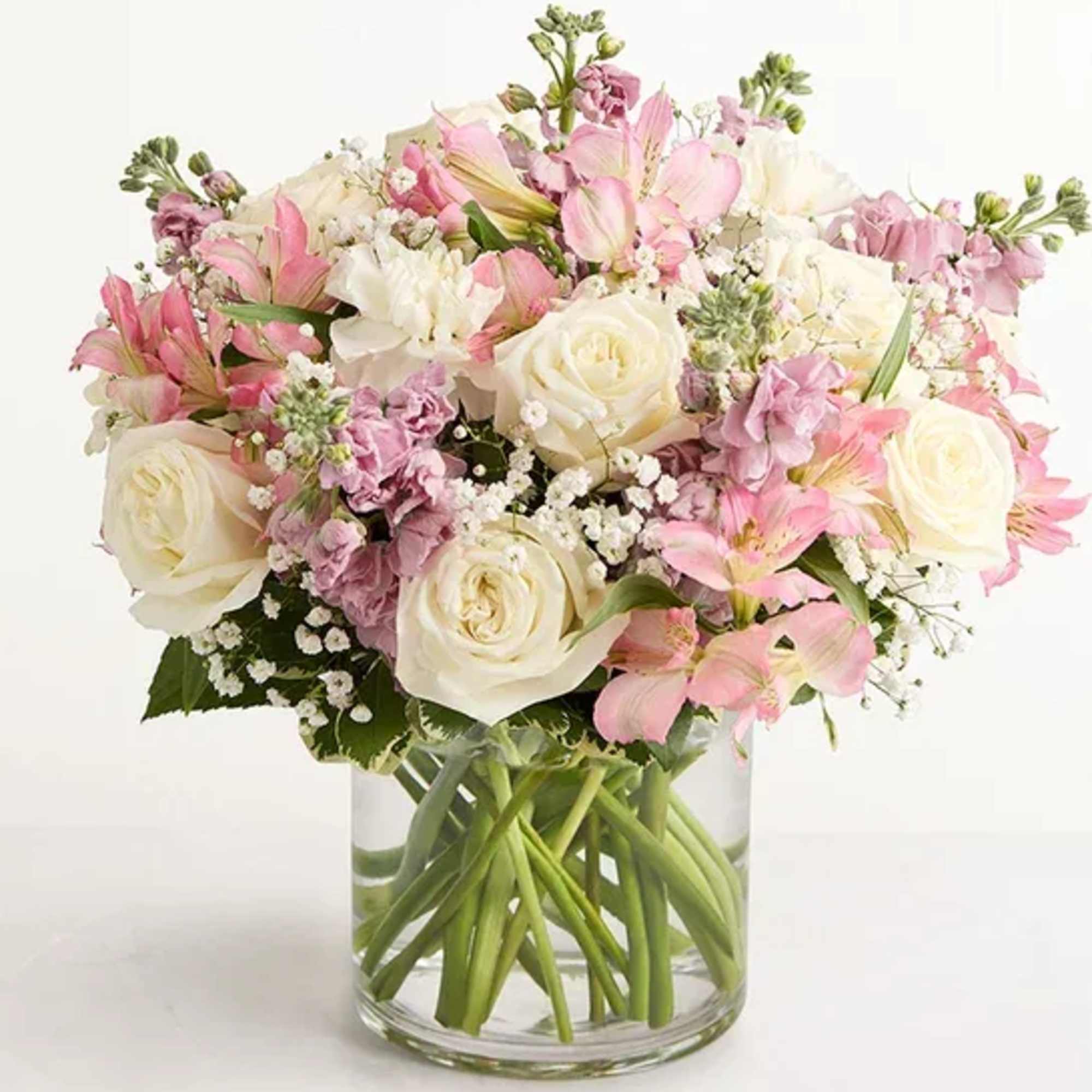 Pink and white bouquet in a clear glass vase