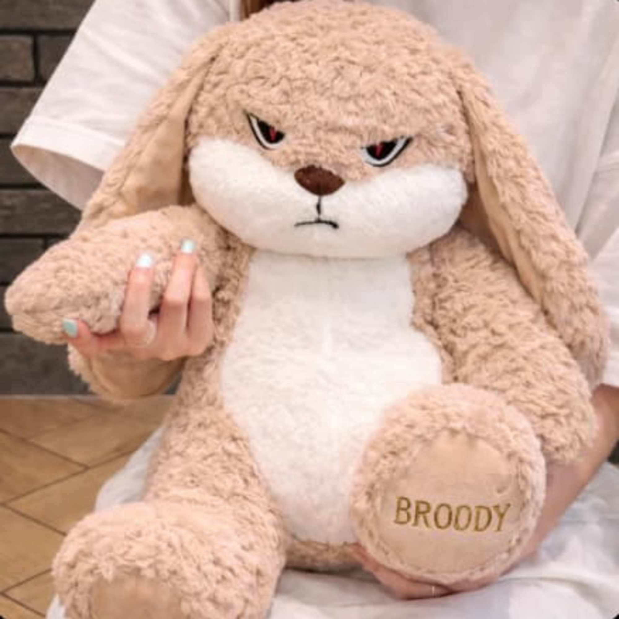 Large beige plush bunny with an embroidered name on its foot