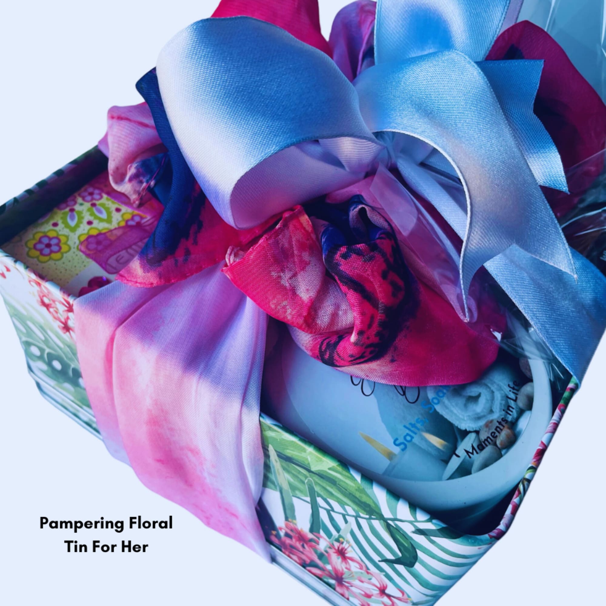 Gift tin with colorful satin ribbons and a floral pattern