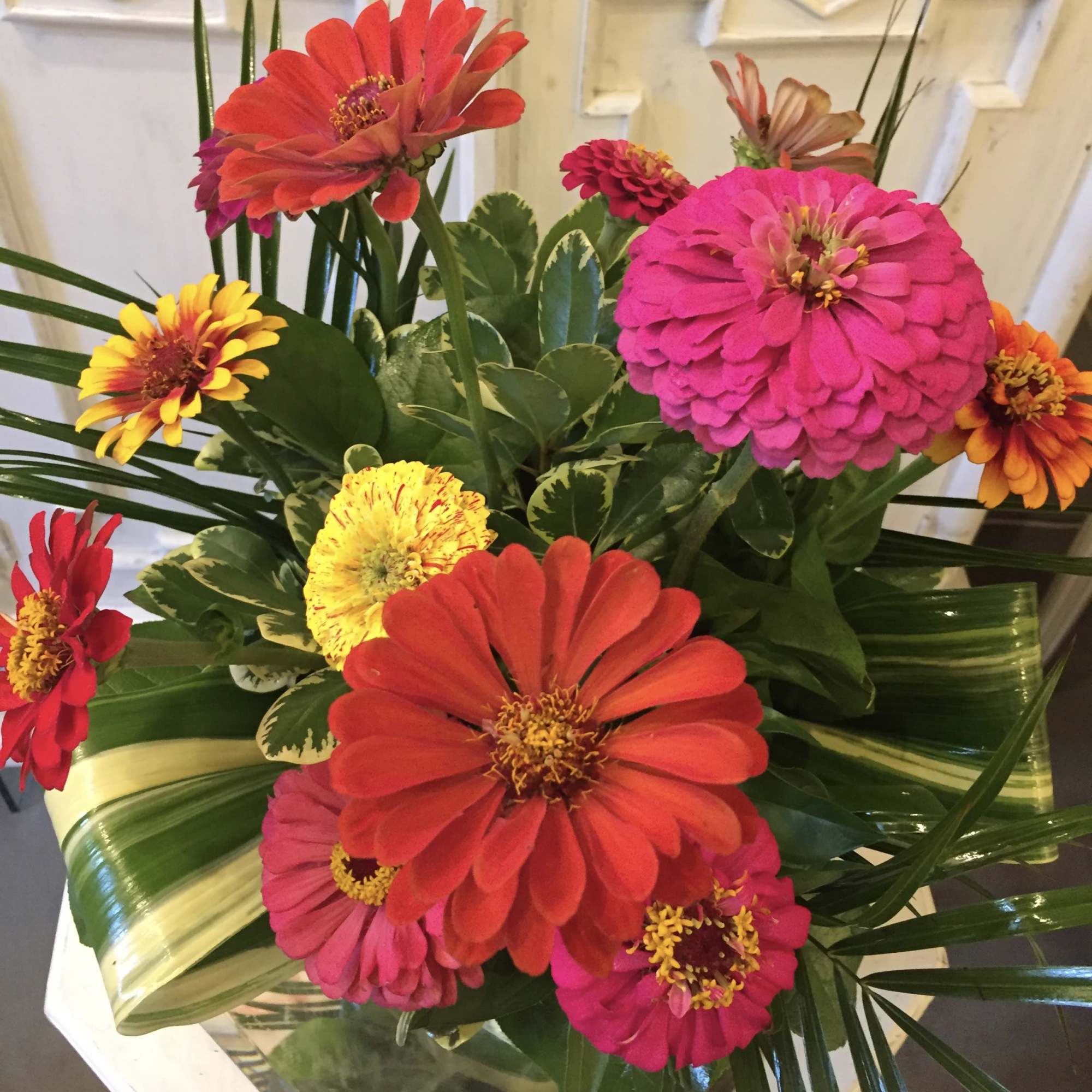 Bright mixed zinnia bouquet with pink, red, yellow, and orange blooms