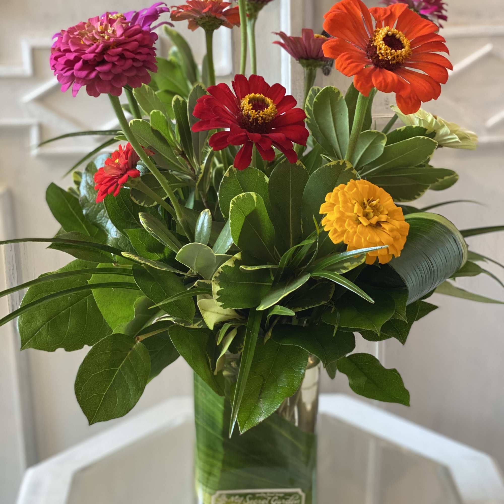 Colorful zinnia bouquet in a clear glass vase