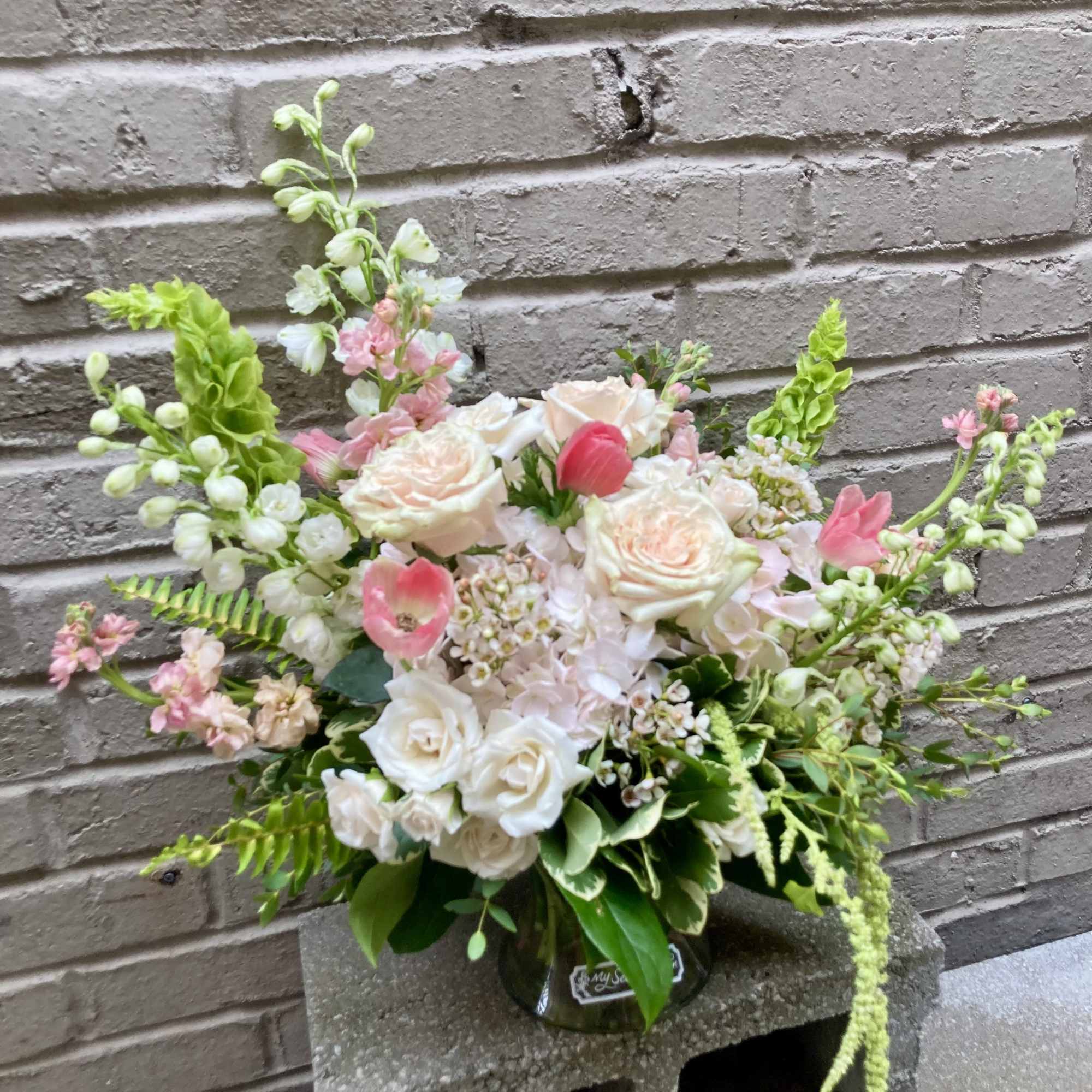 Soft blush roses and airy garden blooms create a delicate, romantic statement-perfect