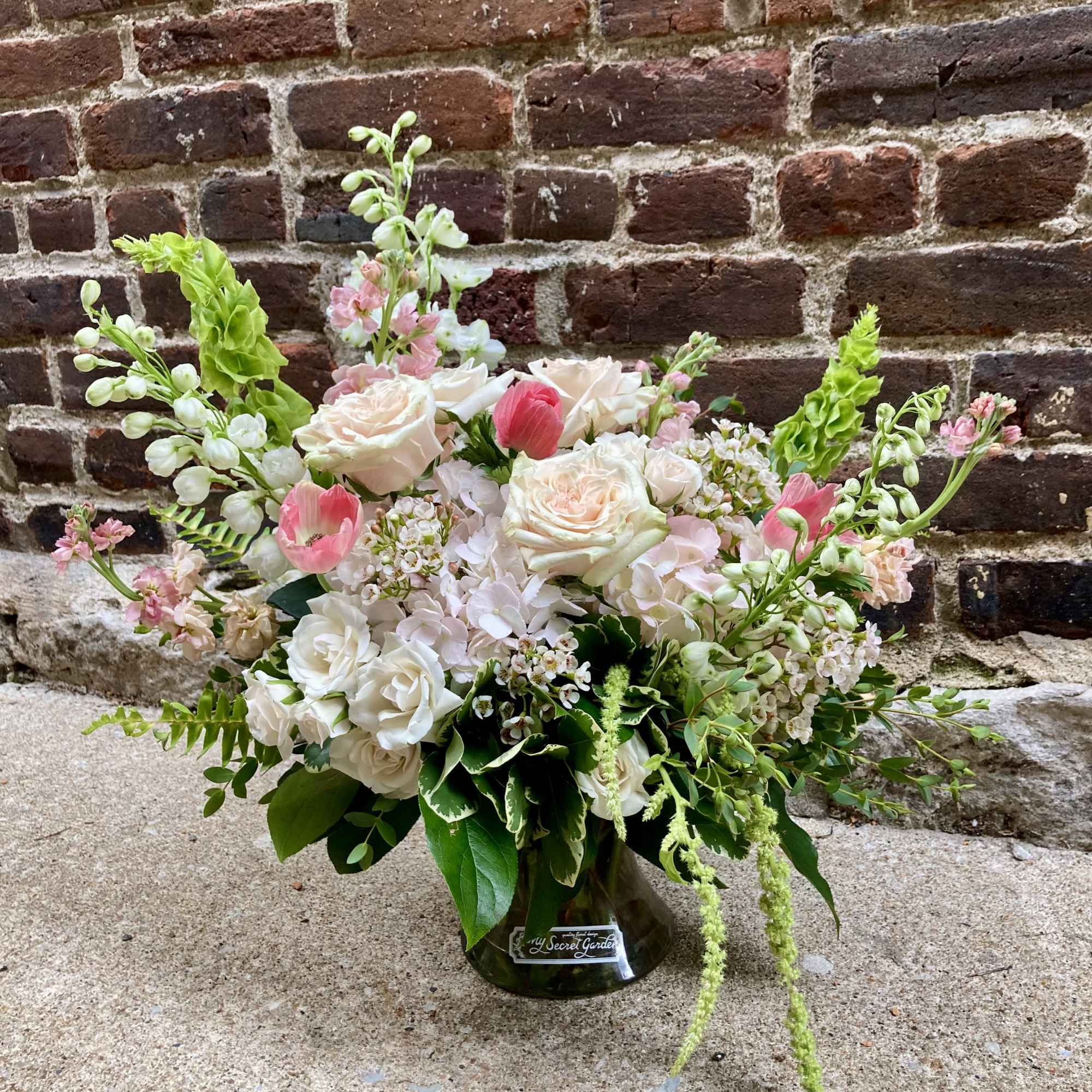 Soft blush roses and airy garden blooms create a delicate, romantic statement-perfect