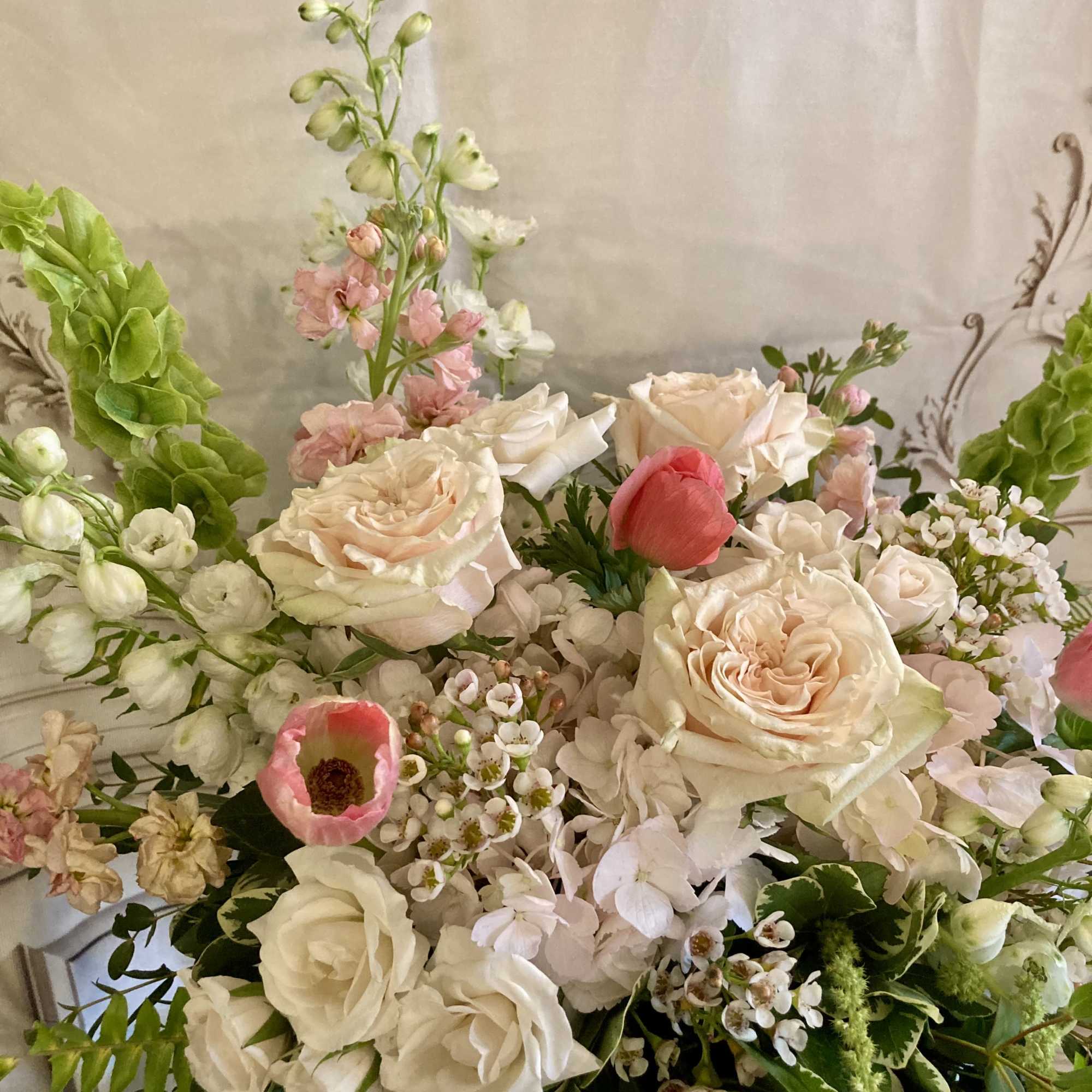 Soft blush roses and airy garden blooms create a delicate, romantic statement-perfect