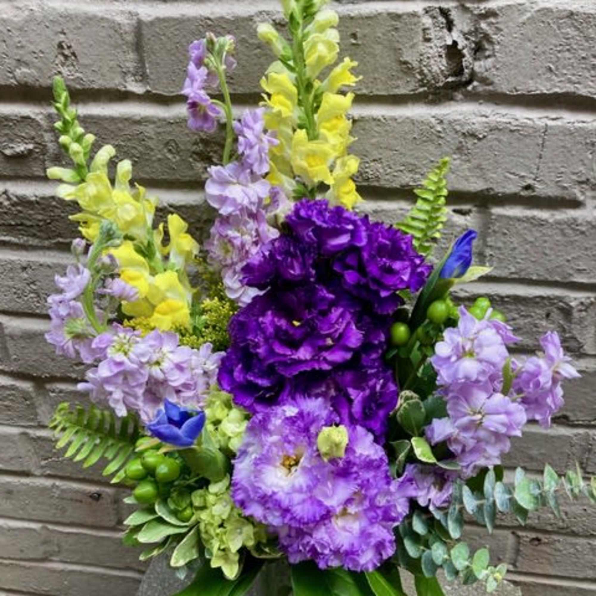 Tall lavender and purple blooms mingle with sunny yellow accents in this