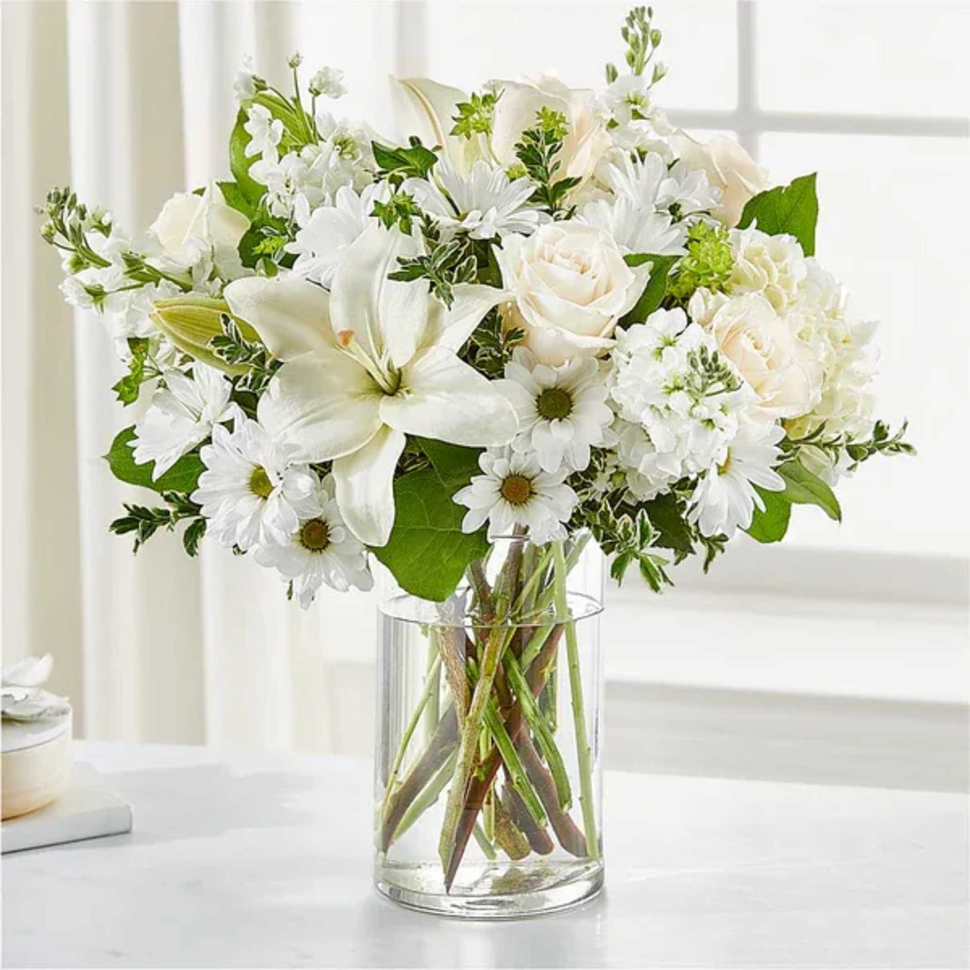 White flowers arranged in a clear glass vase