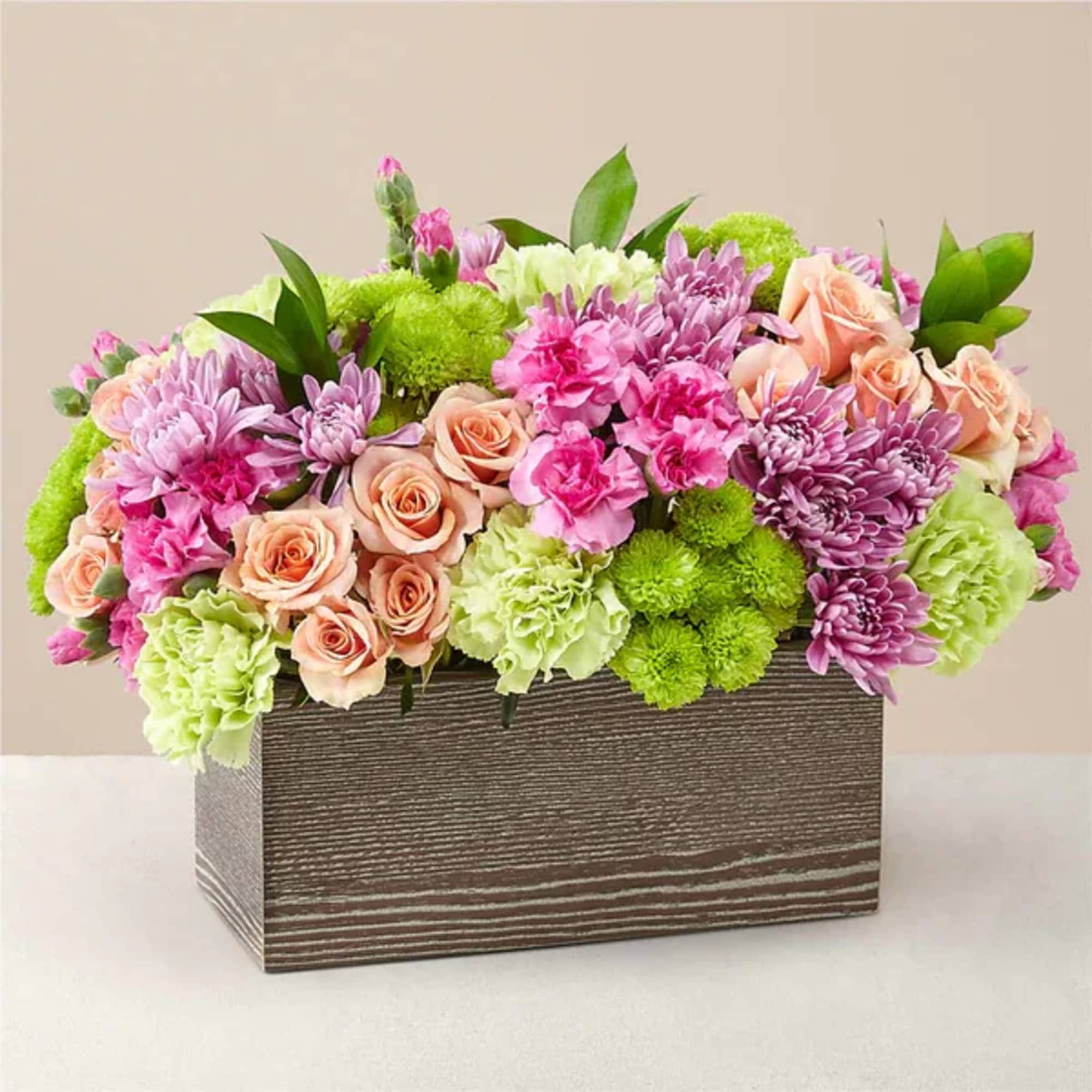 Mixed pink and green flower arrangement in a rectangular wooden box