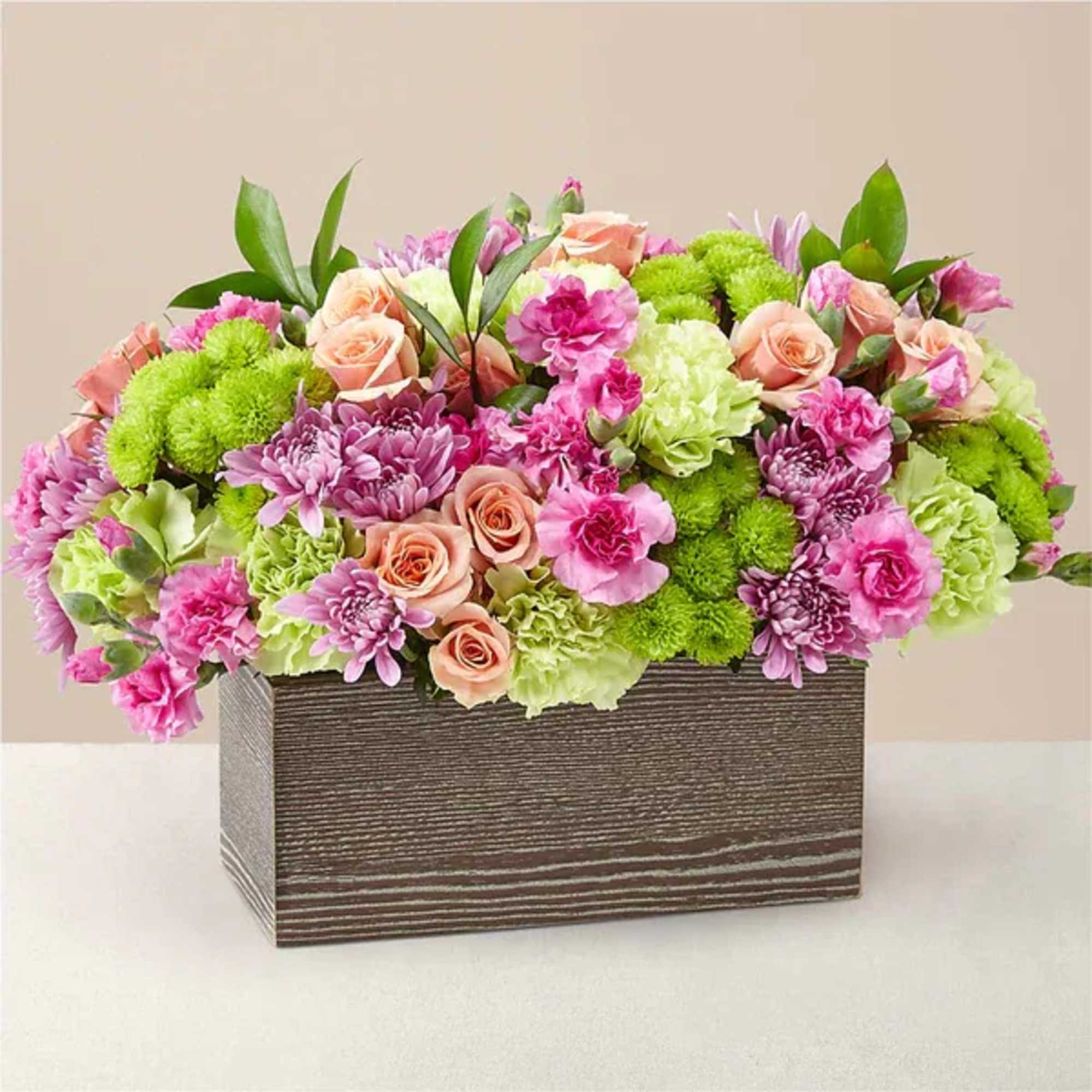 Pink and green mixed flower arrangement in a rectangular wooden box