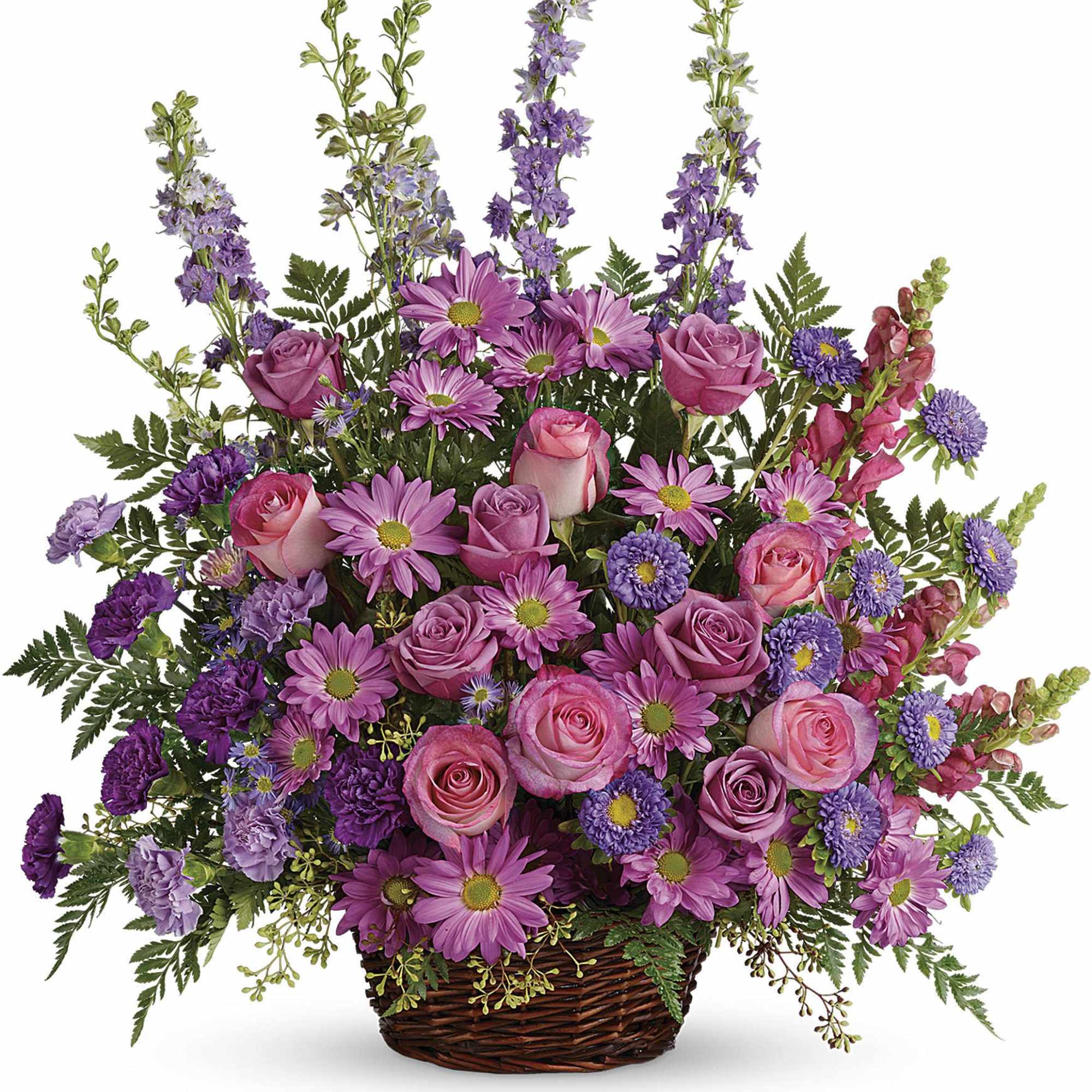 Tall pink and purple flower arrangement with roses and daisies in a brown wicker basket