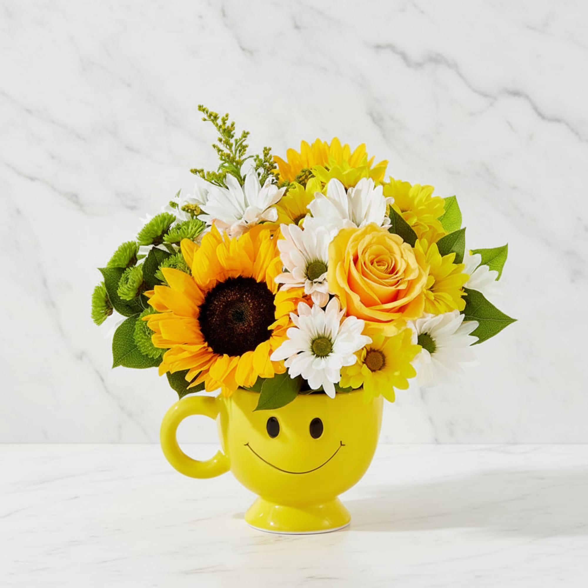 Yellow mug with a smiley face holding sunflowers, daisies, and a yellow rose