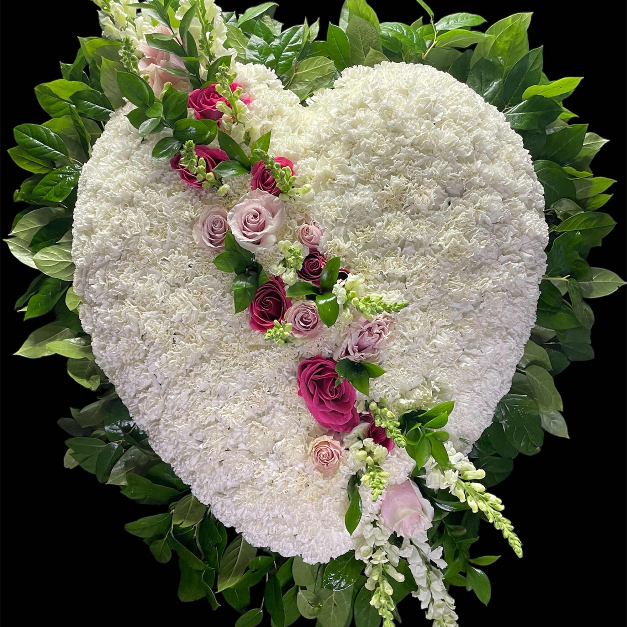 Heart-shaped white floral arrangement with pink roses and greenery