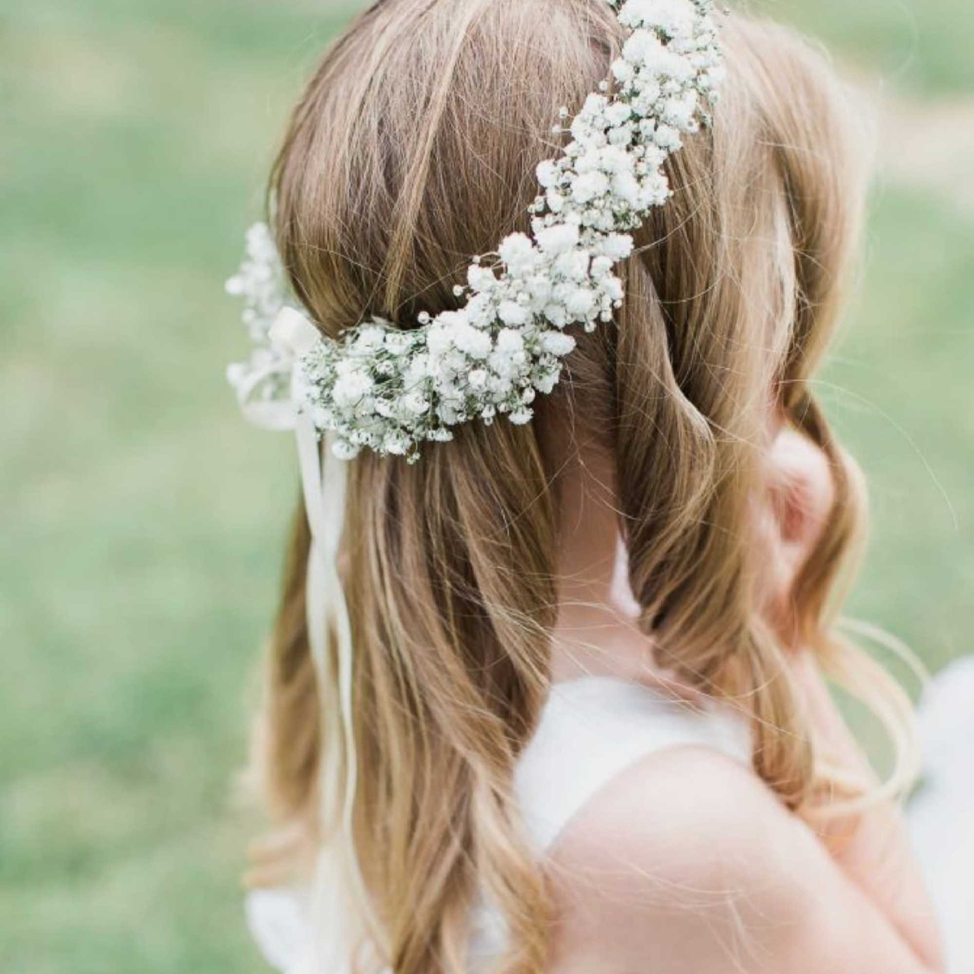 Girl wearing a white floral crown in her hair