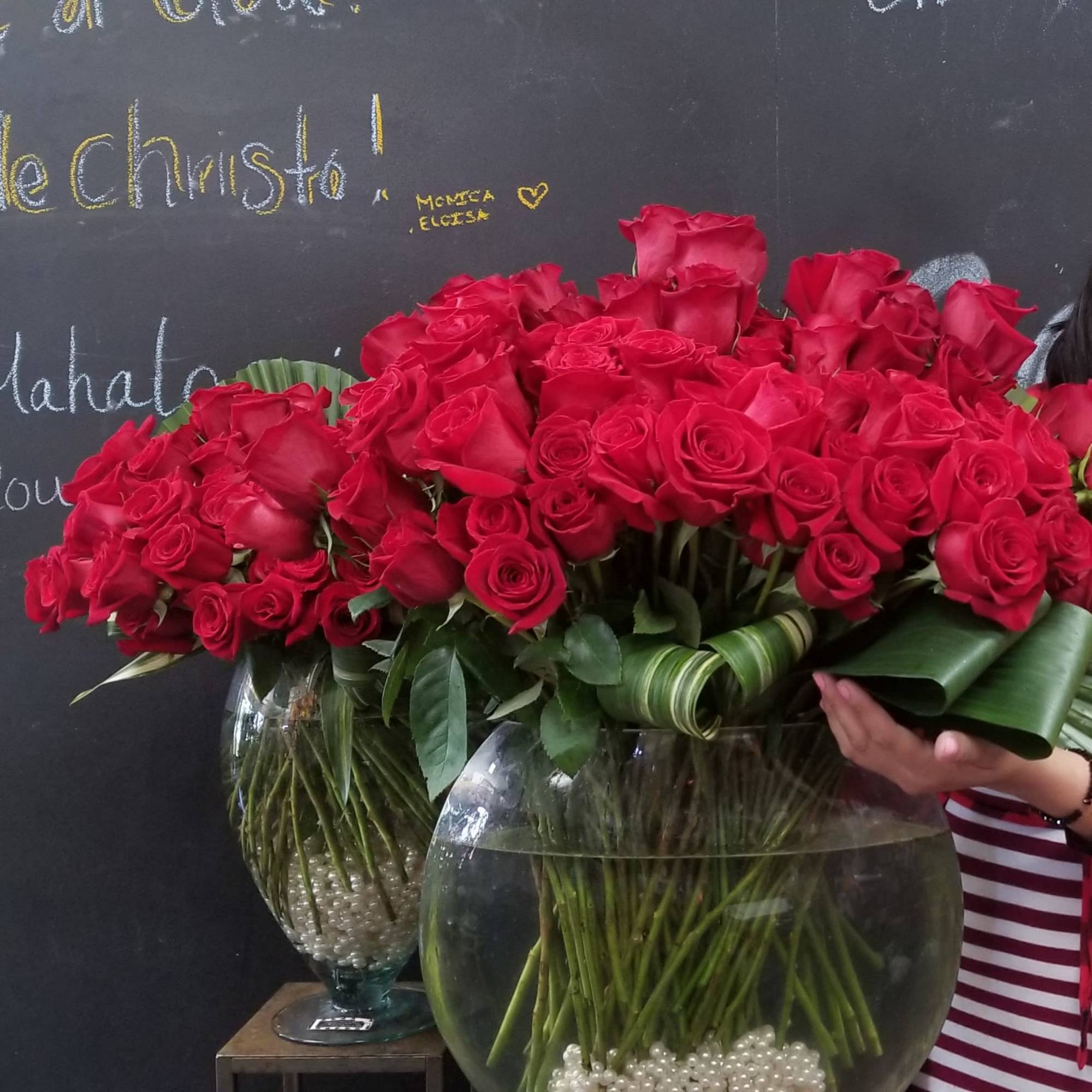 Large bouquet of red roses in glass vases