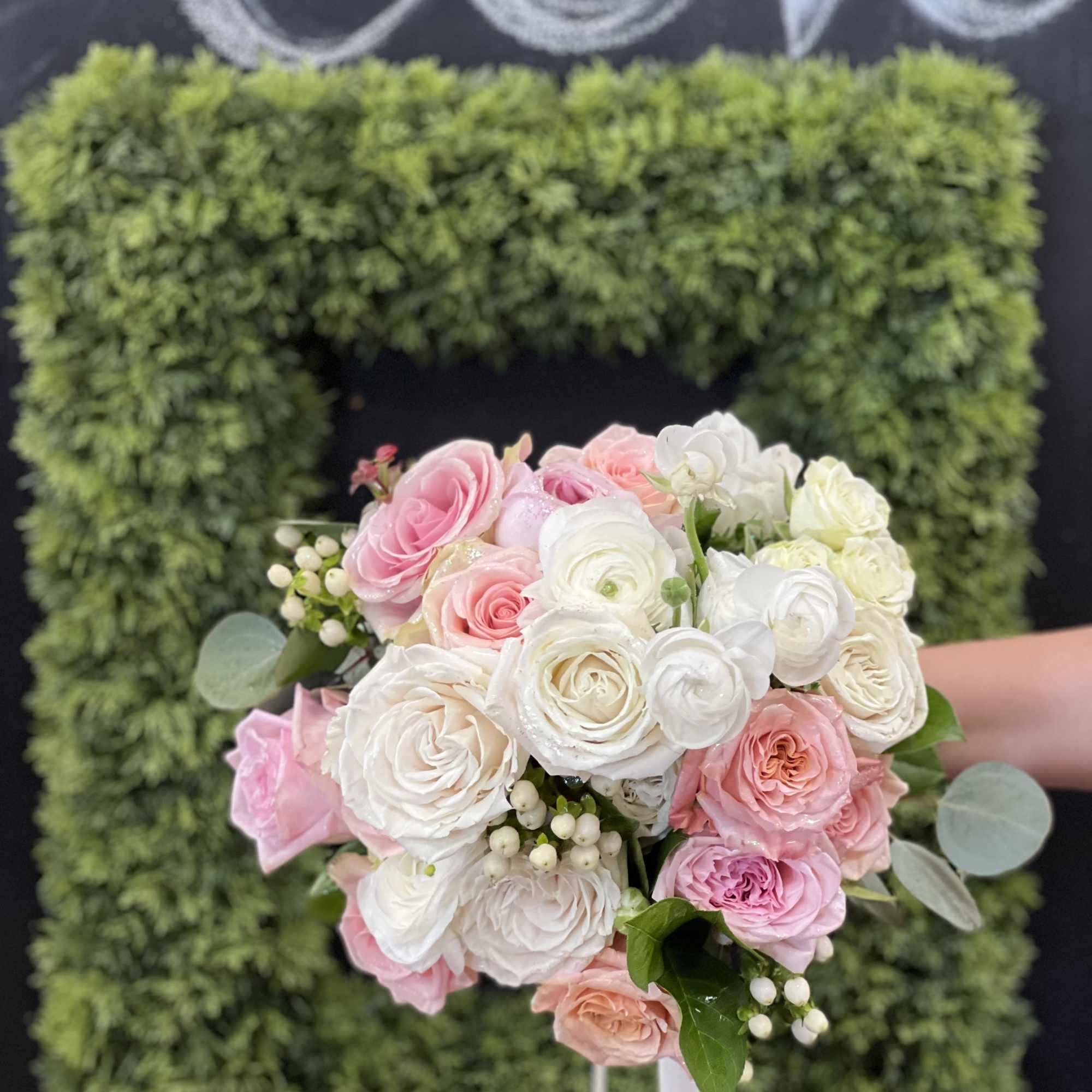 Pink and white rose bouquet with berries and ribbon