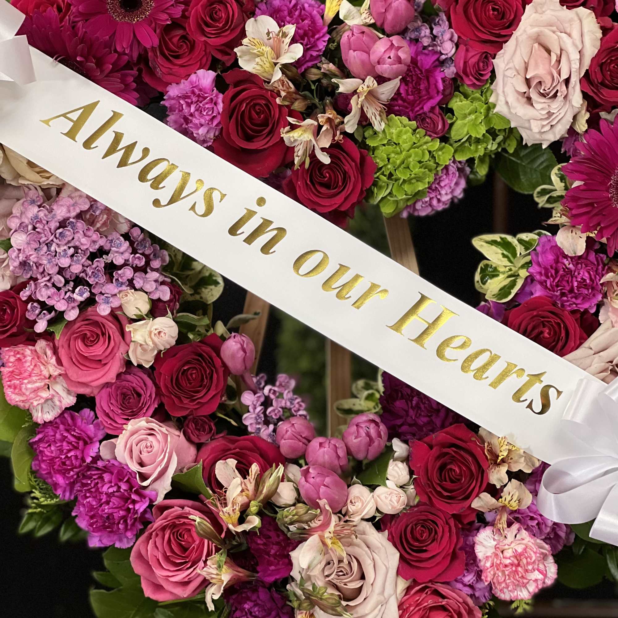 Heart-shaped floral wreath with pink and red roses and a white ribbon, photo 2 of 5