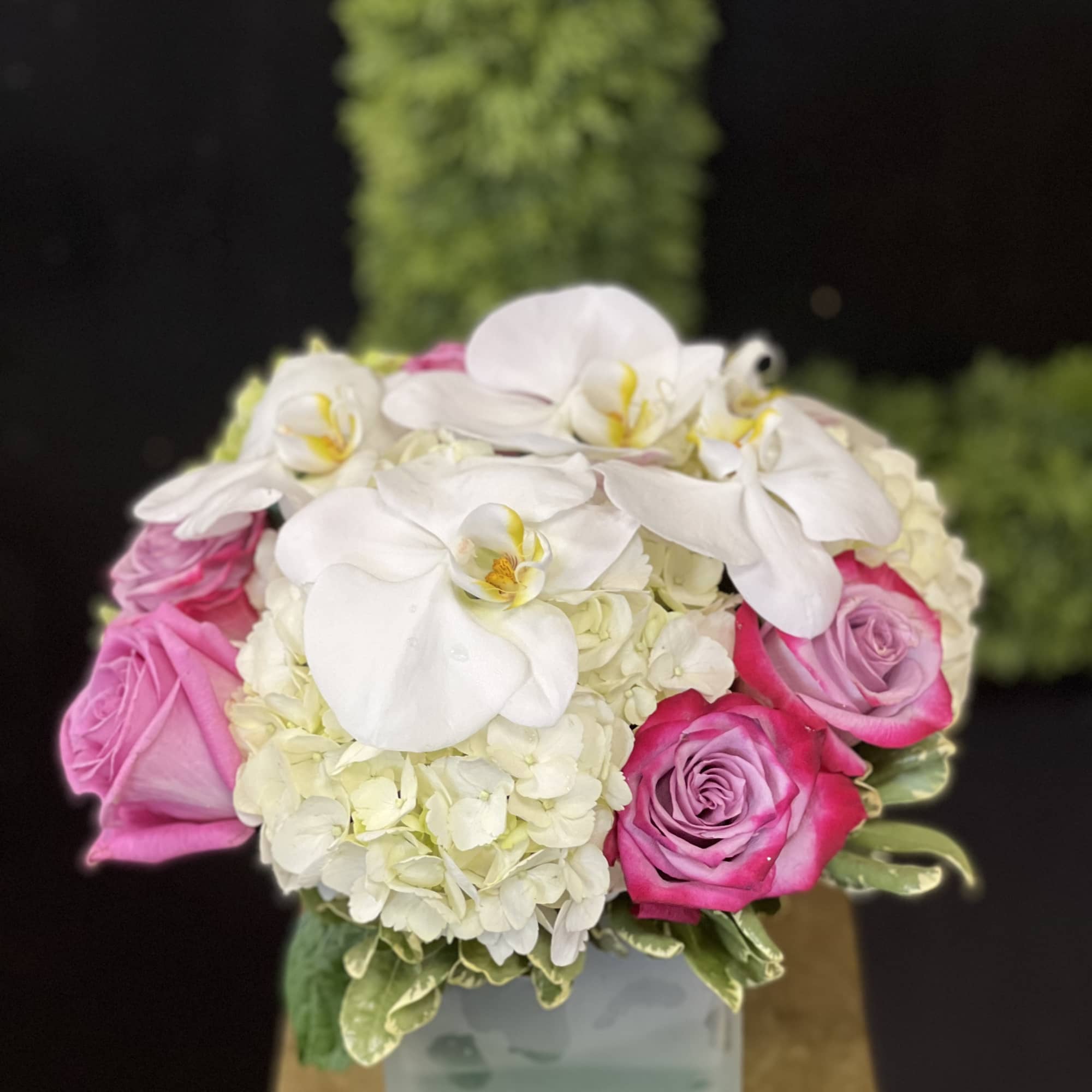 Pink roses and white orchids arranged in a square vase, photo 2 of 3