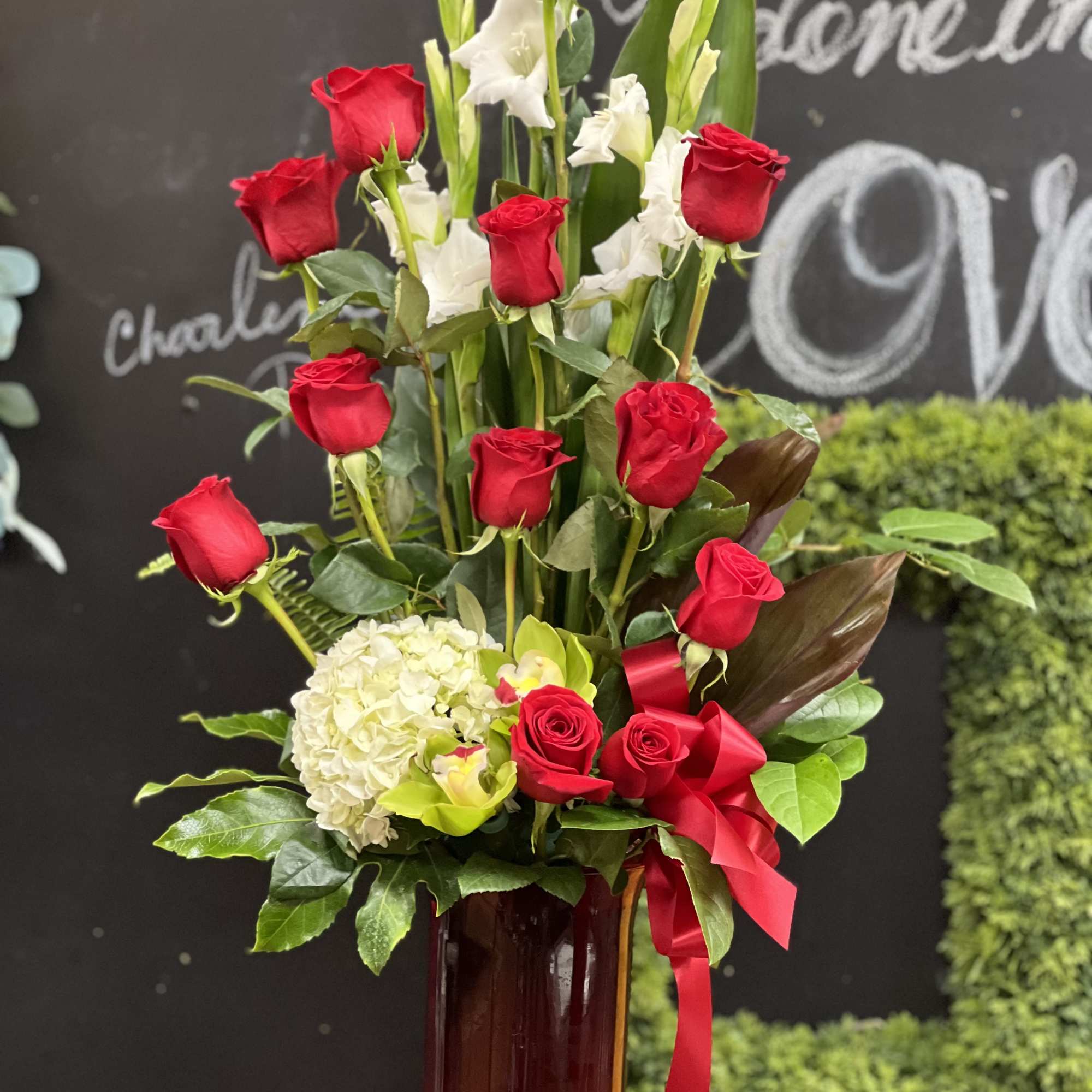 Tall arrangement of red roses and white flowers in a glass vase, photo 3 of 3