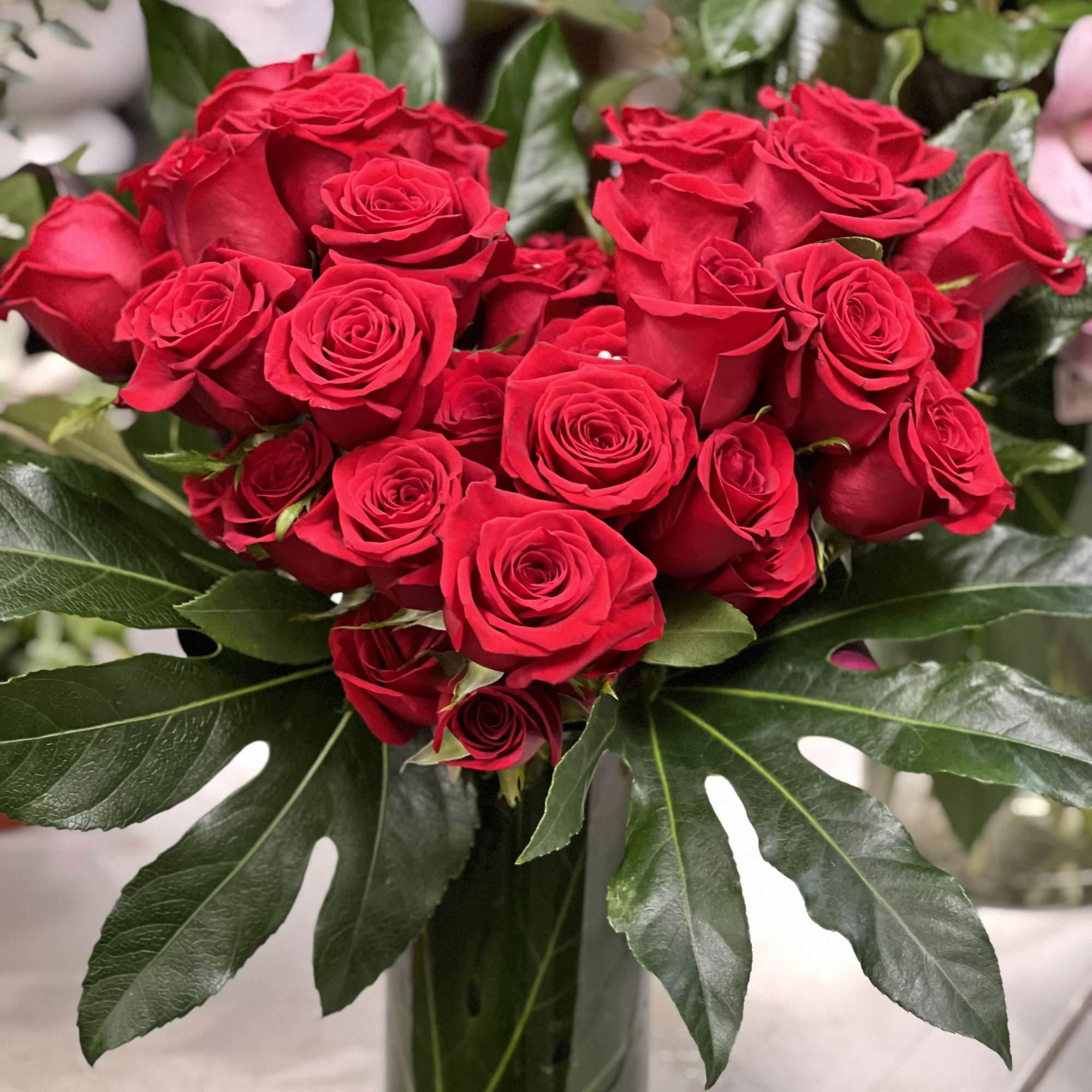 Red rose bouquet in a clear glass vase